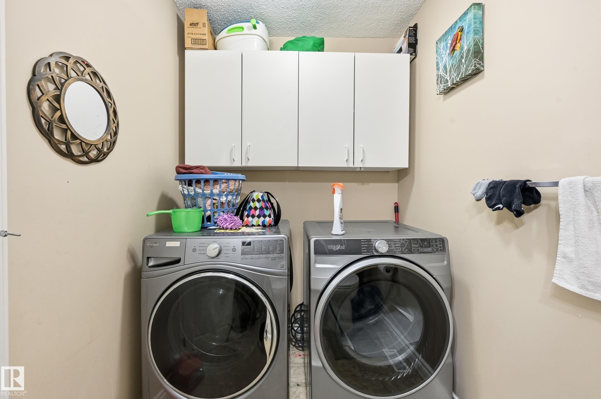 Washroom with cabinet space, a textured ceiling, and independent washer and dryer - 3010 32 Avenue Nw, Edmonton, AB - Indoor Photo Showing Laundry Room