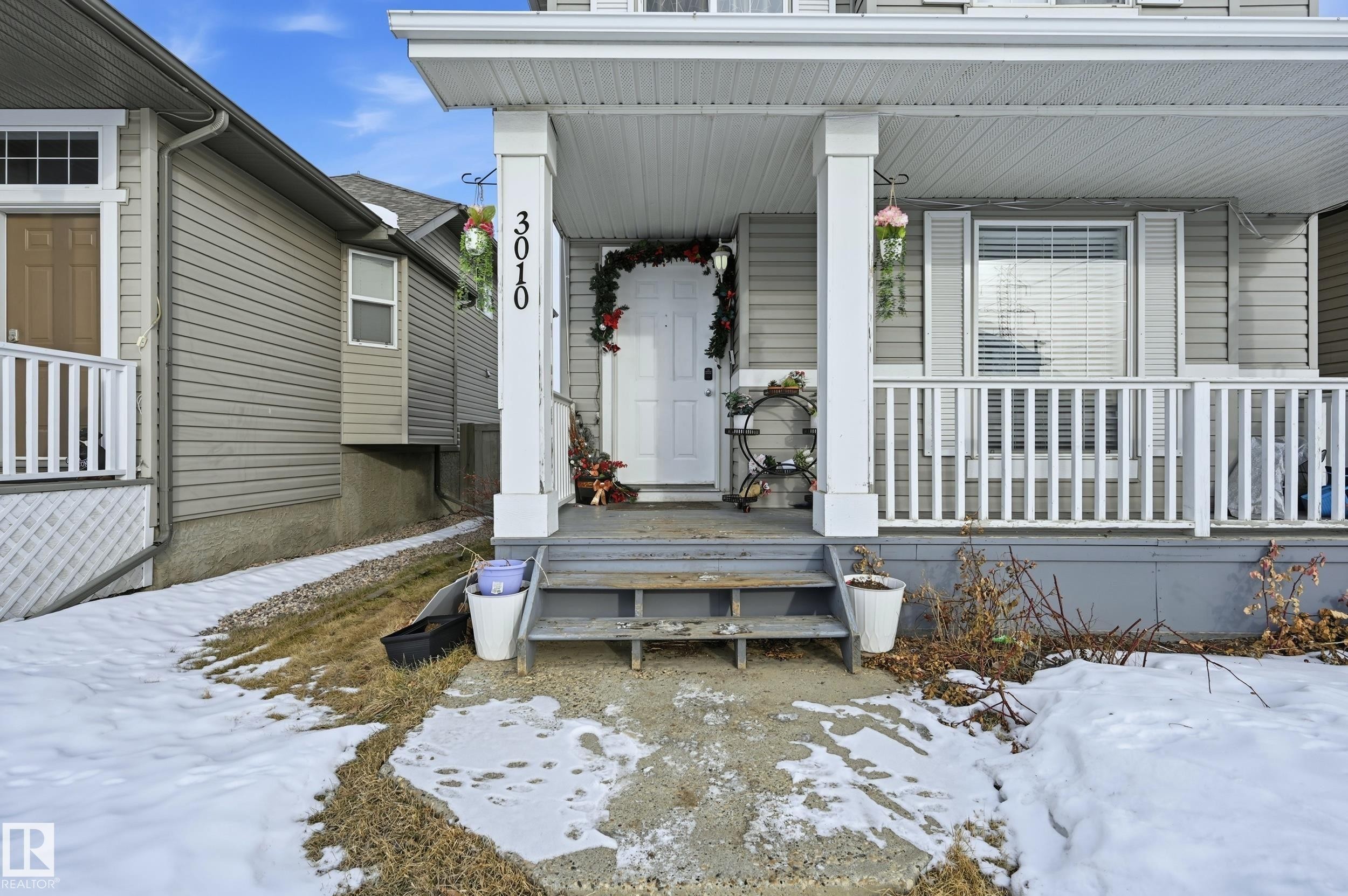 Snow covered property entrance with a porch - 3010 32 Avenue Nw, Edmonton, AB - Outdoor With Deck Patio Veranda