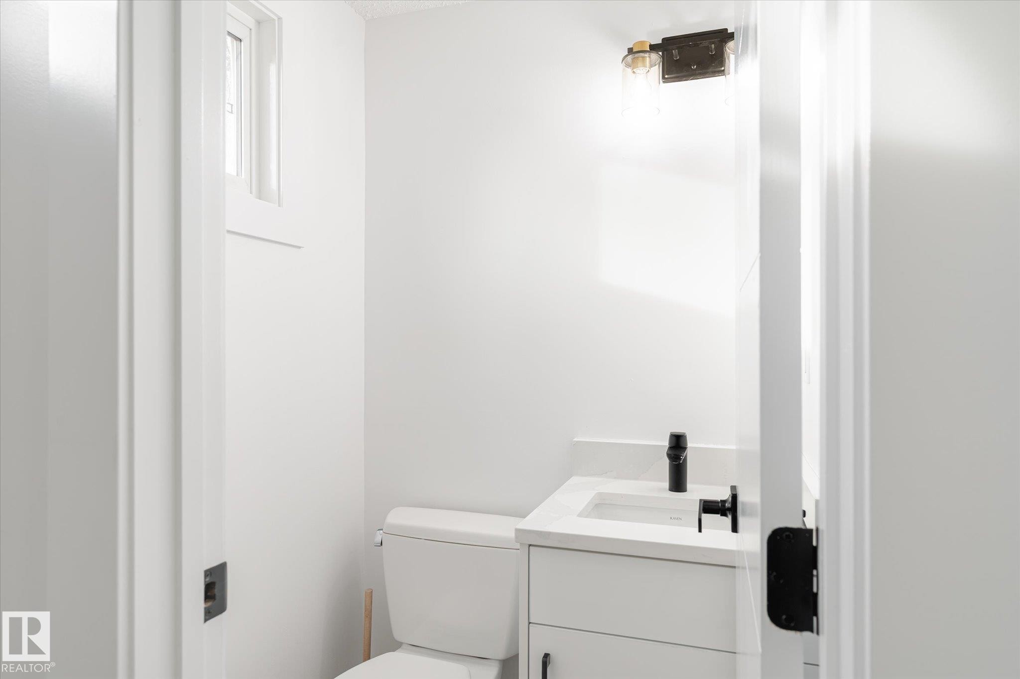 Bathroom with vanity and toilet - 5105 106A Street, Edmonton, AB - Indoor Photo Showing Bathroom