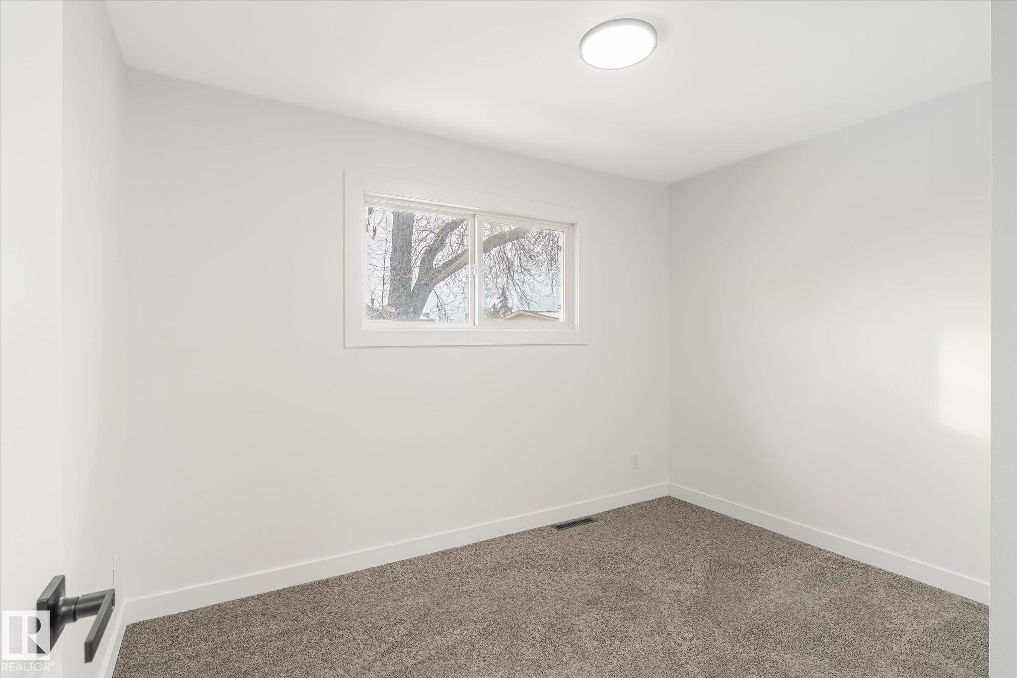 Empty room featuring baseboards and carpet flooring - 5105 106A Street, Edmonton, AB - Indoor Photo Showing Other Room