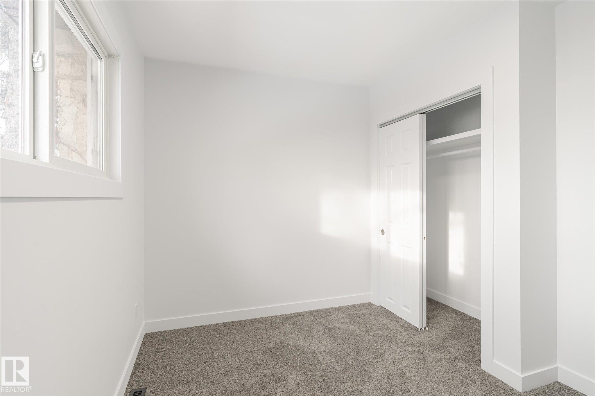 Unfurnished bedroom featuring carpet and a closet - 5105 106A Street, Edmonton, AB - Indoor Photo Showing Other Room