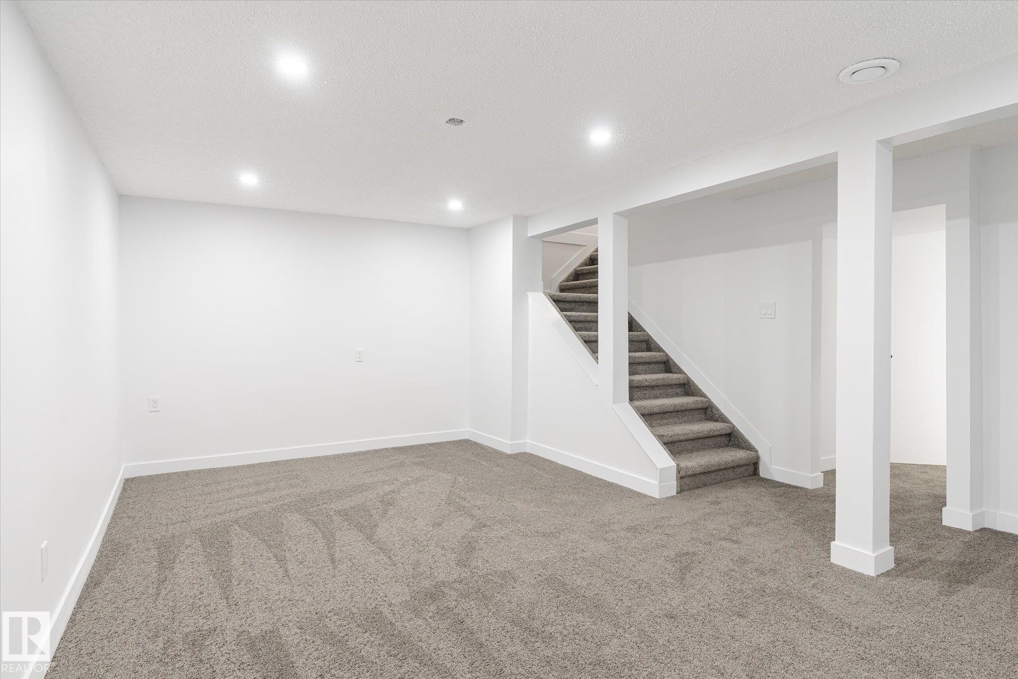 Finished basement featuring carpet floors, stairs, and recessed lighting - 5105 106A Street, Edmonton, AB - Indoor