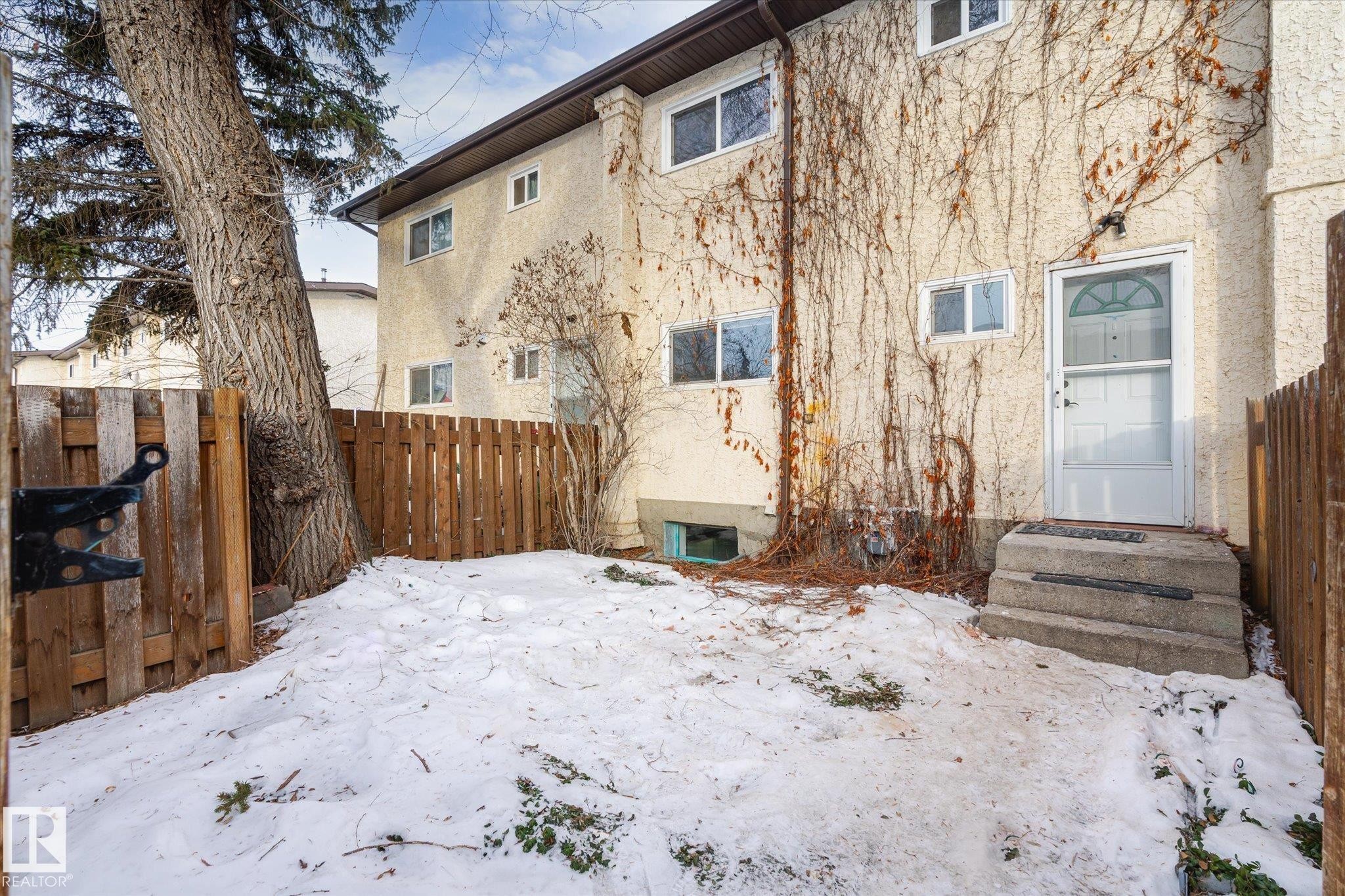 Snow covered property with stucco siding - 5105 106A Street, Edmonton, AB - Outdoor