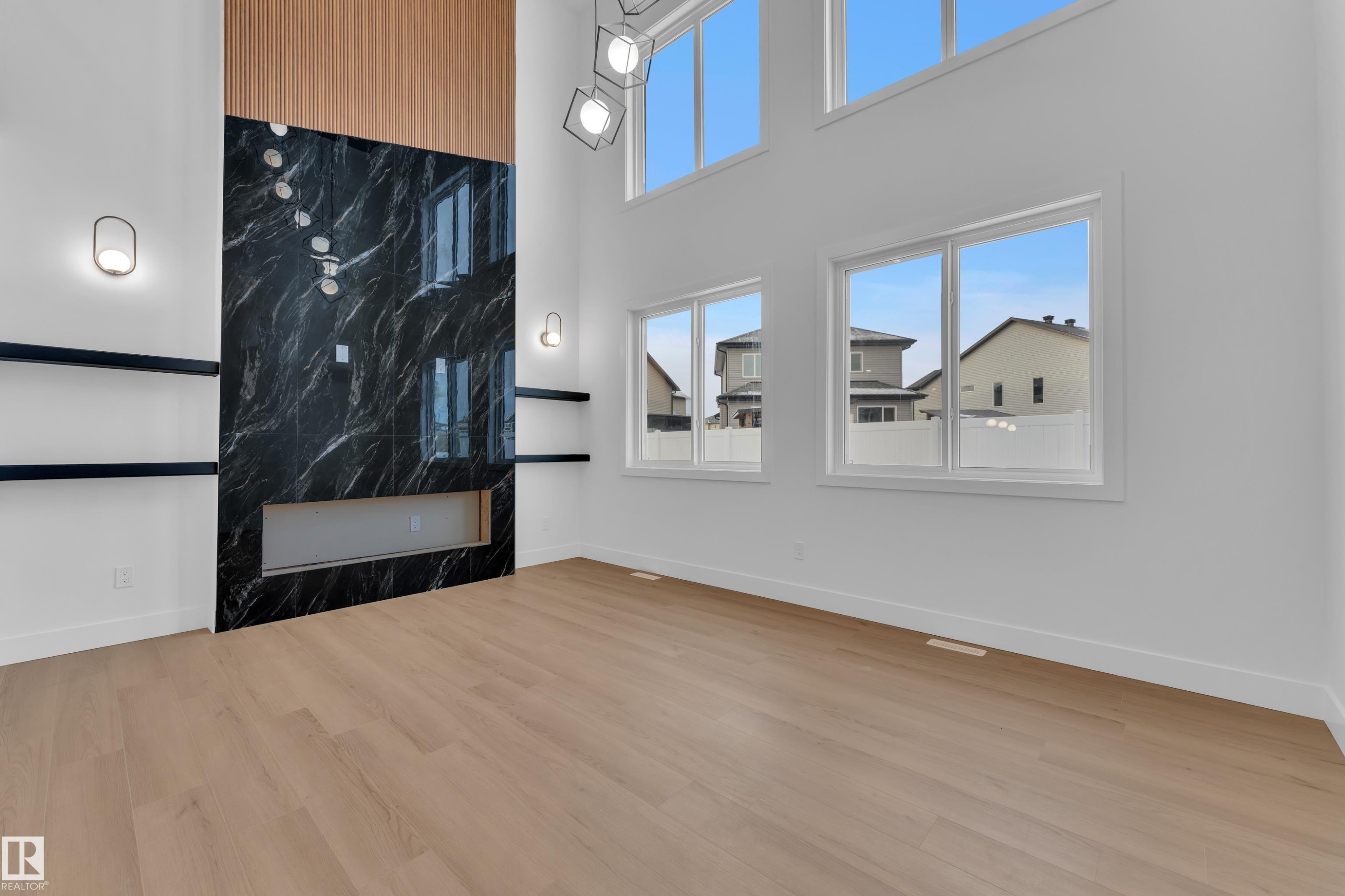 Unfurnished living room featuring a high ceiling and light wood-type flooring - 733 Astoria Way, Devon, AB - Indoor Photo Showing Other Room