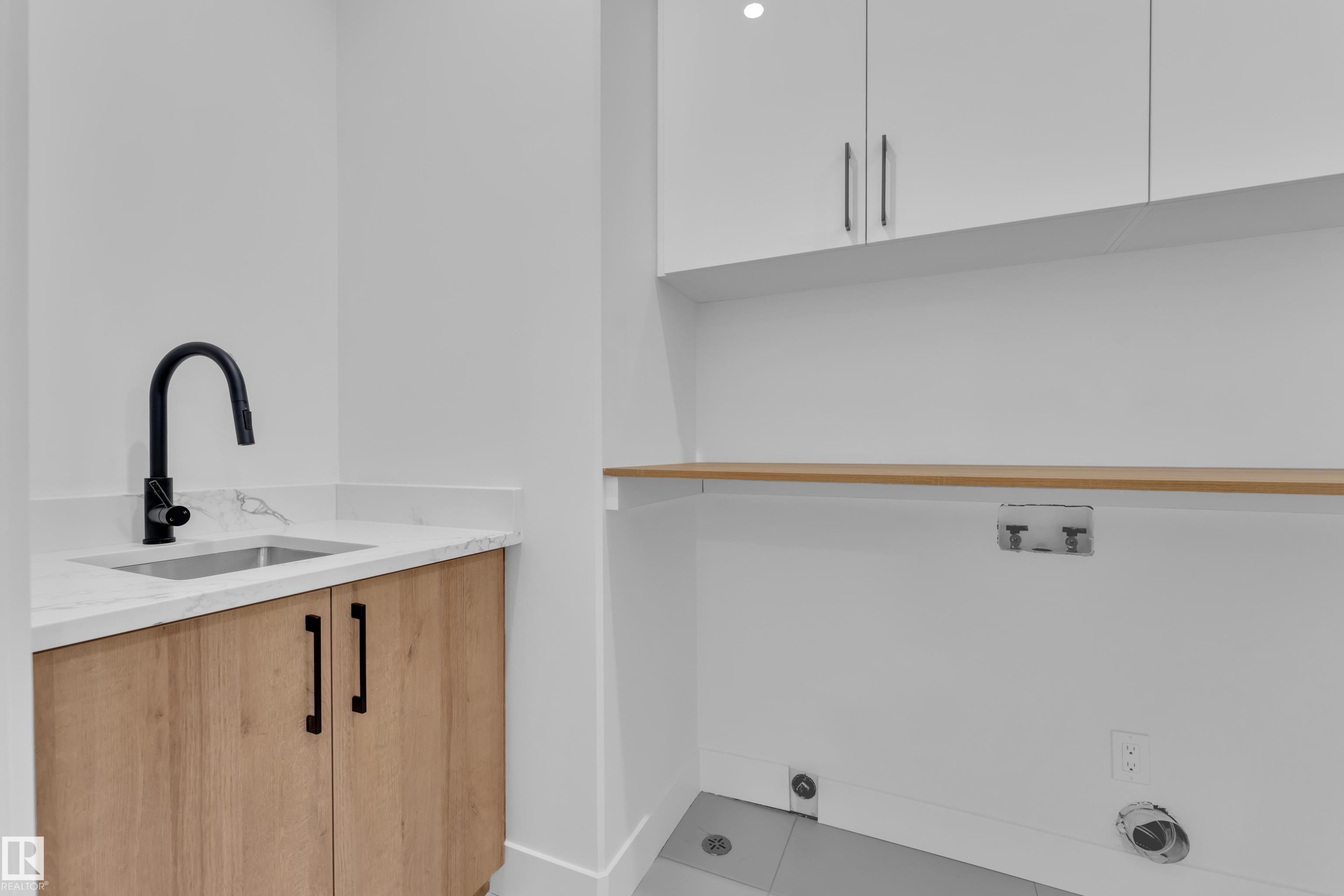Laundry room featuring cabinet space, tile patterned flooring, and washer hookup - 733 Astoria Way, Devon, AB - Indoor
