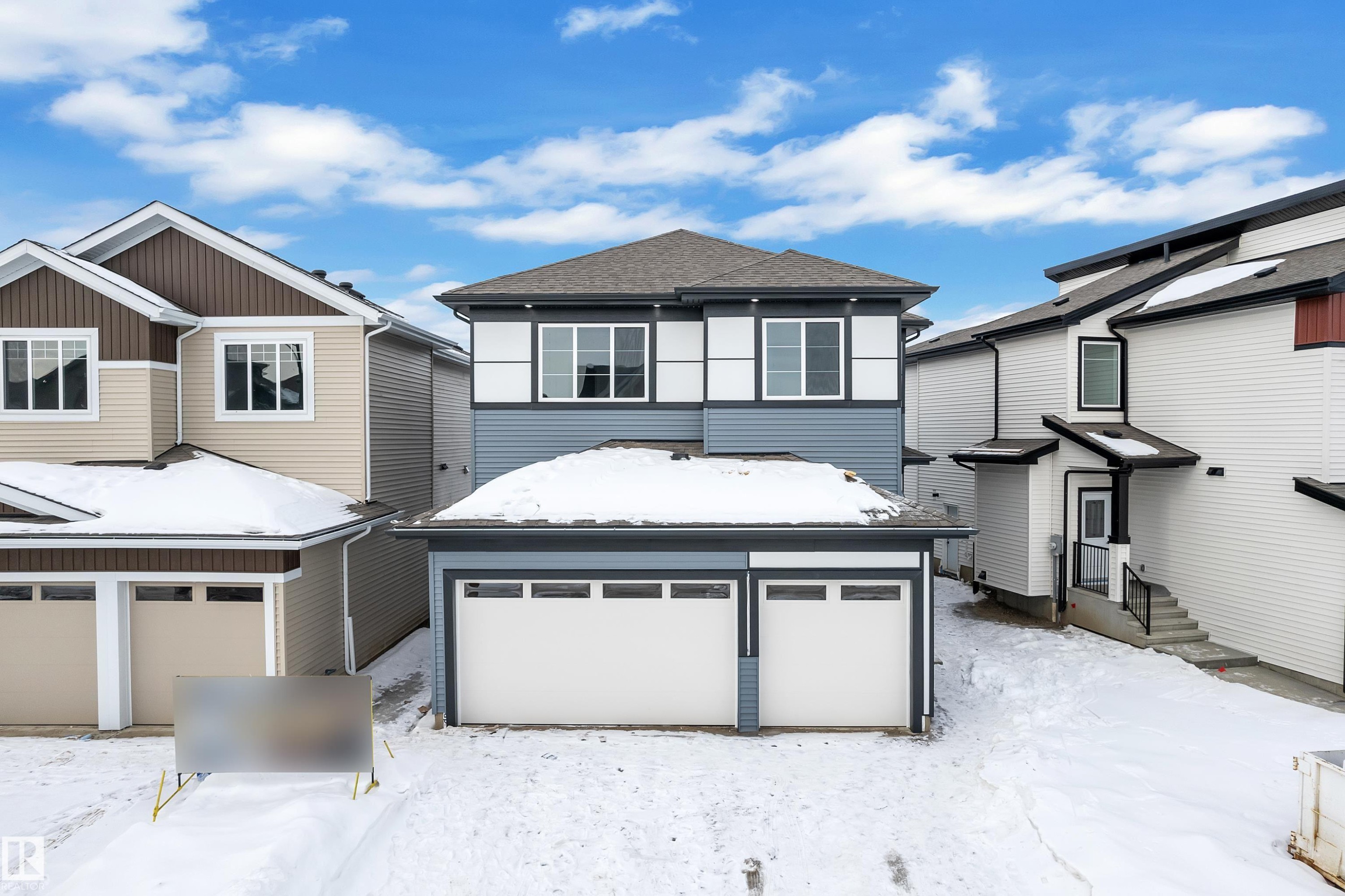 View of front of house featuring an attached garage and a shingled roof - 733 Astoria Way, Devon, AB - Outdoor