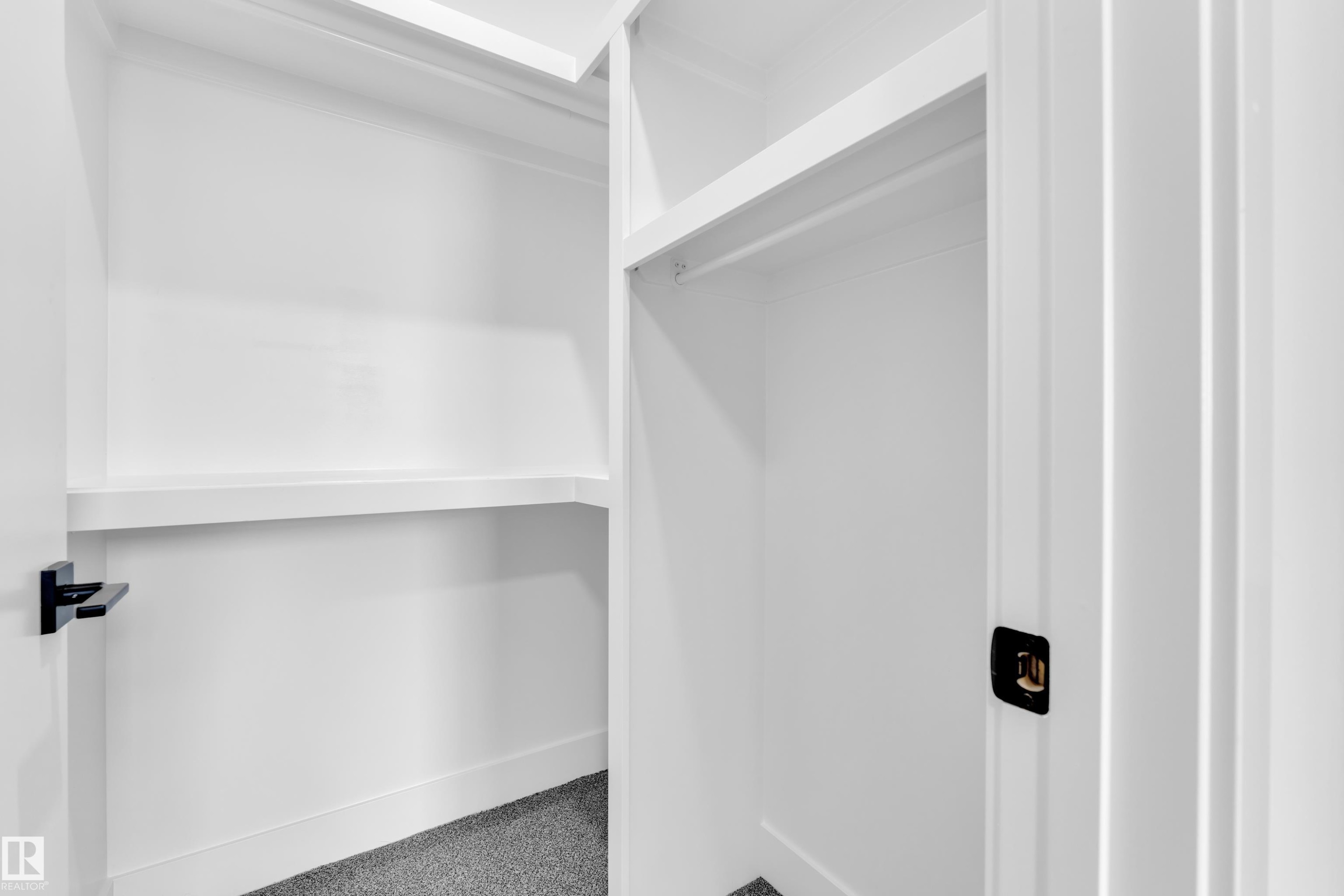Walk in closet featuring carpet floors - 733 Astoria Way, Devon, AB - Indoor With Storage