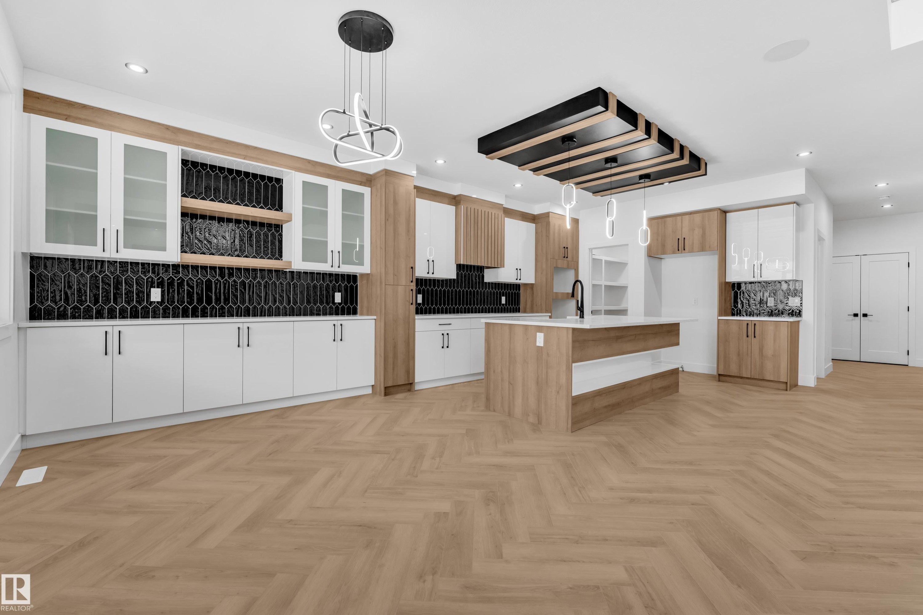 Two tone kitchen with open shelves, decorative light fixtures, parquet flooring, an island with sink, and two tone cabinetry - 737 Astoria Way, Devon, AB - Indoor Photo Showing Kitchen