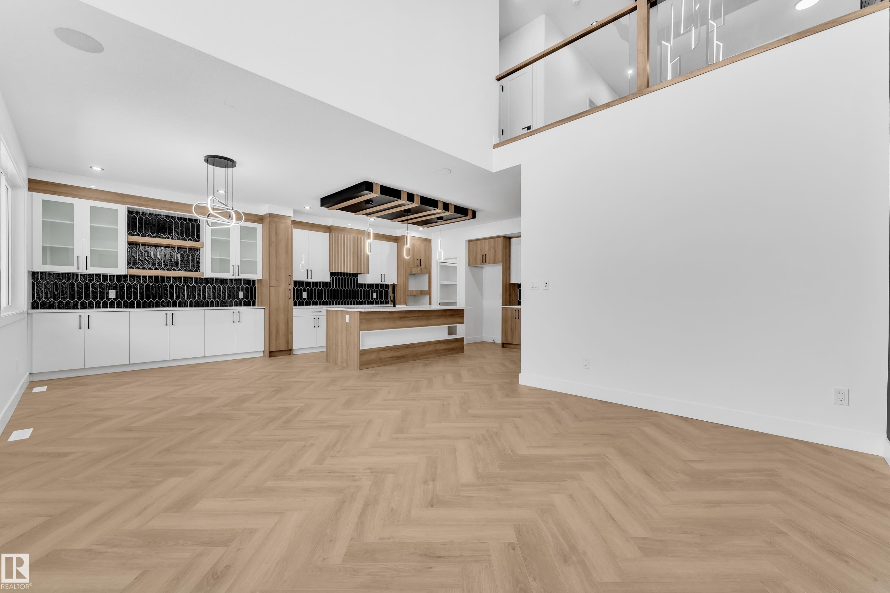 Kitchen with glass fronted cabinets, open floor plan, a breakfast bar area, parquet floors, and light countertops - 737 Astoria Way, Devon, AB - Indoor