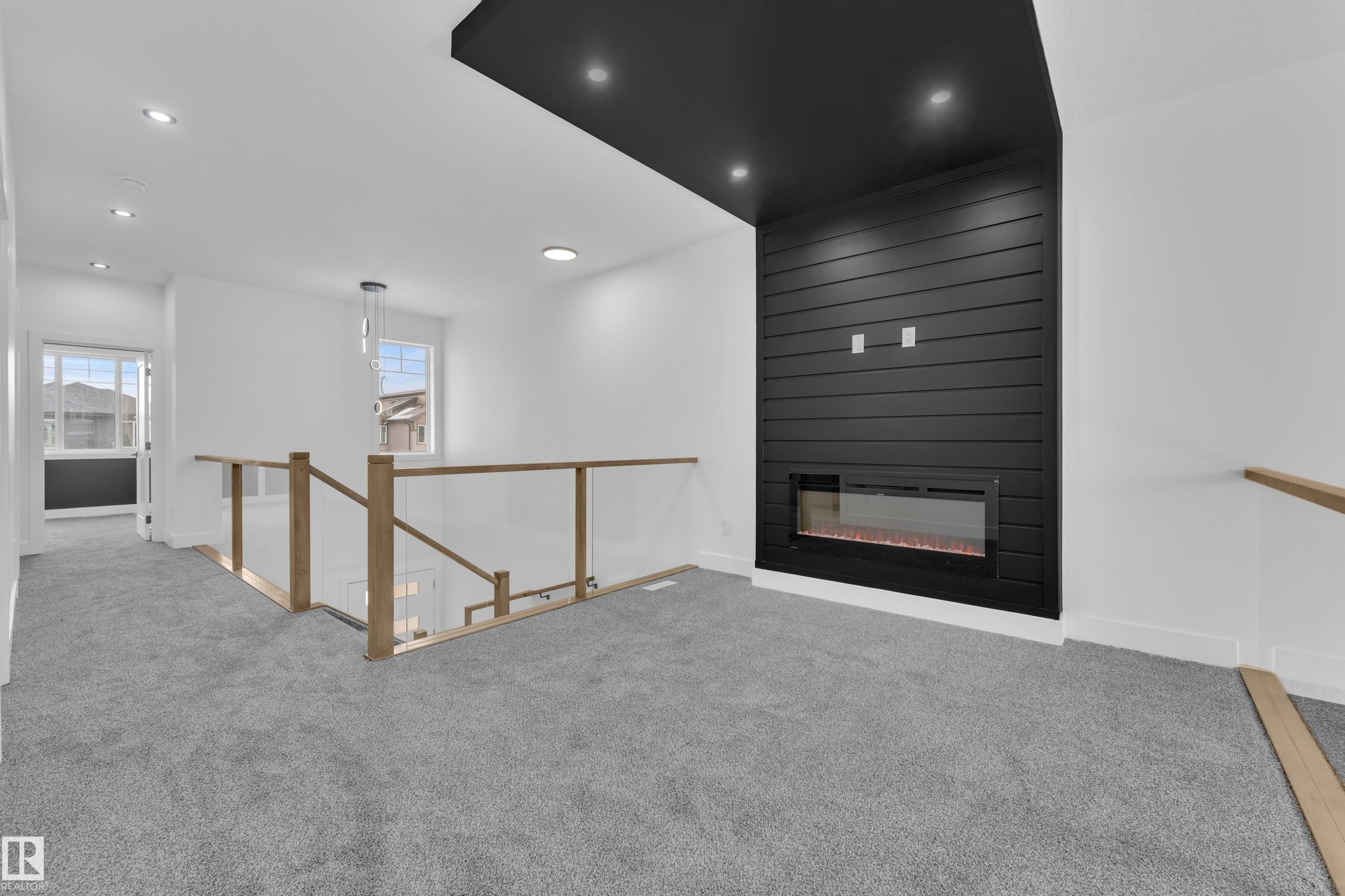 Carpeted spare room with recessed lighting and a large fireplace - 737 Astoria Way, Devon, AB - Indoor With Fireplace