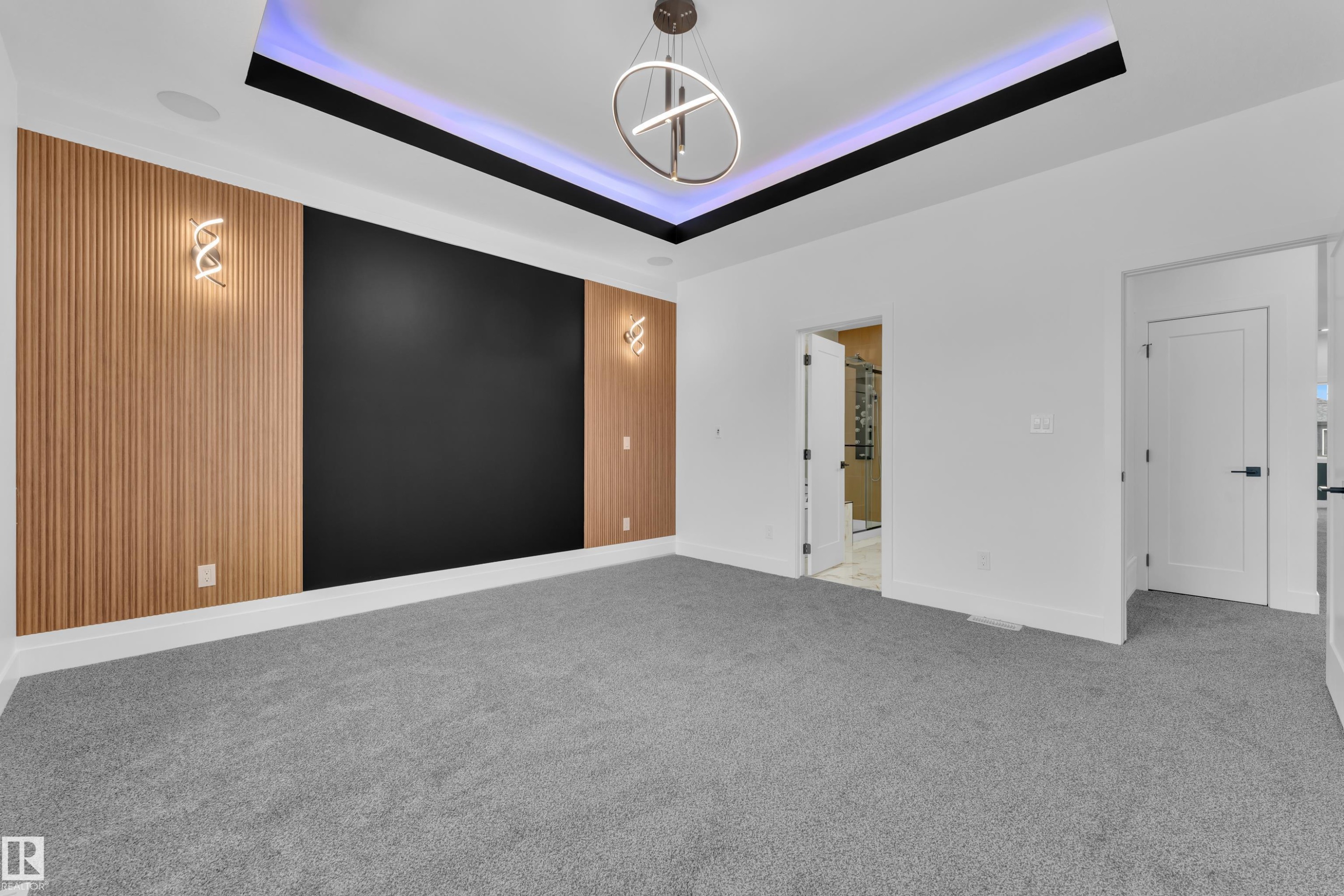 Empty room with carpet floors, a chandelier, and a raised ceiling - 737 Astoria Way, Devon, AB - Indoor Photo Showing Other Room
