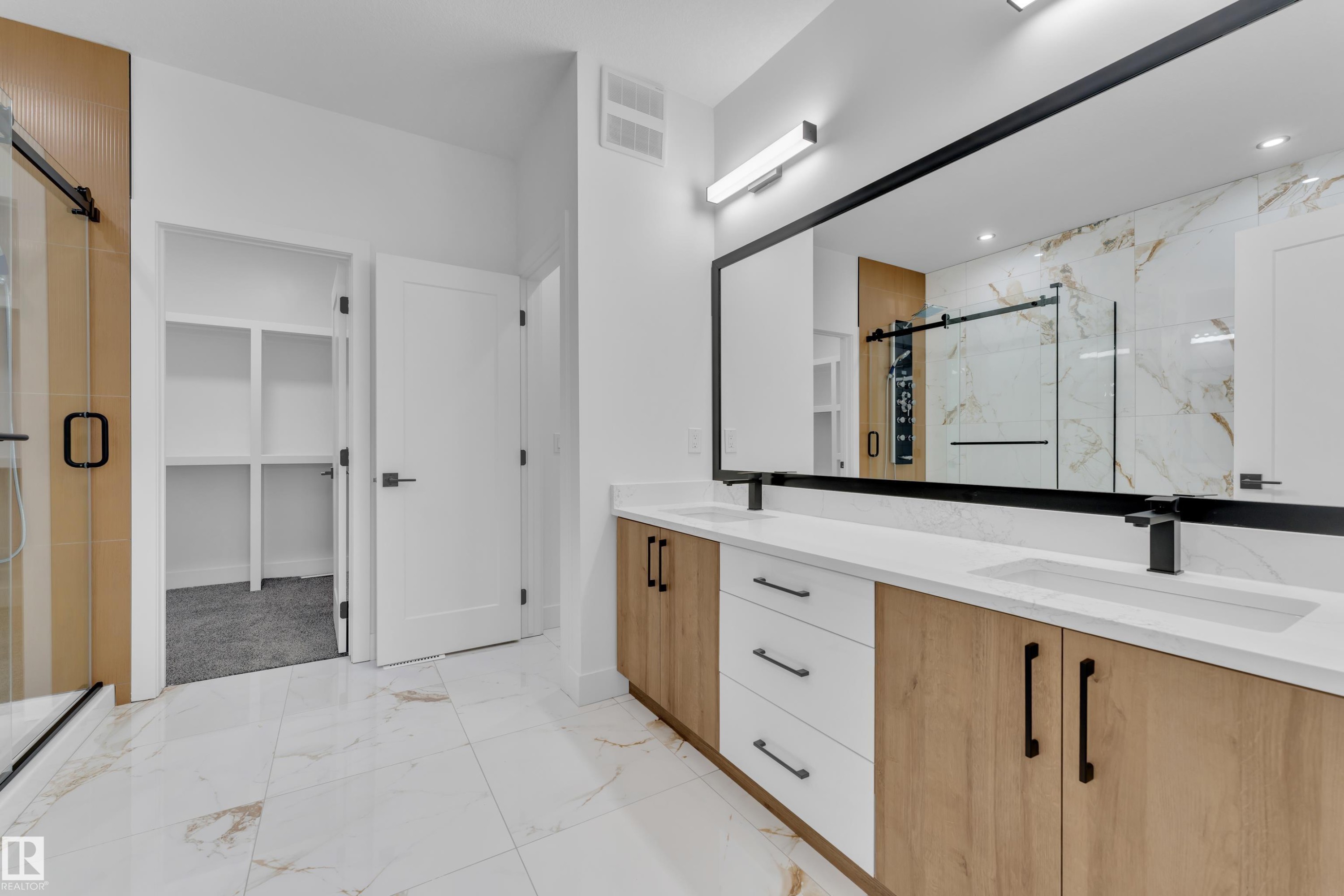 Full bathroom featuring a walk in closet, a marble finish shower, light marble finish floors, and double vanity - 737 Astoria Way, Devon, AB - Indoor