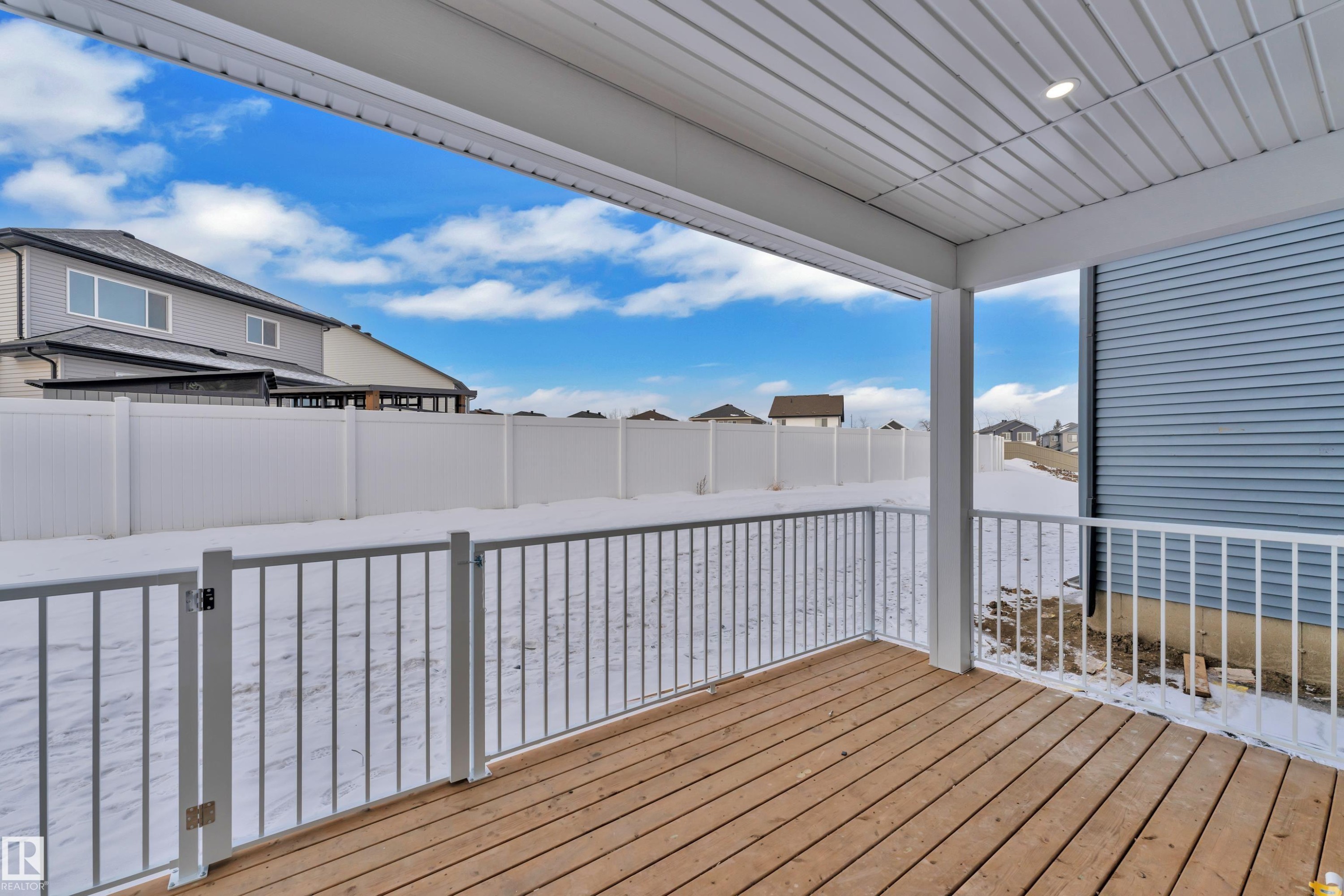 Wooden deck with a residential view - 737 Astoria Way, Devon, AB - Outdoor With Exterior