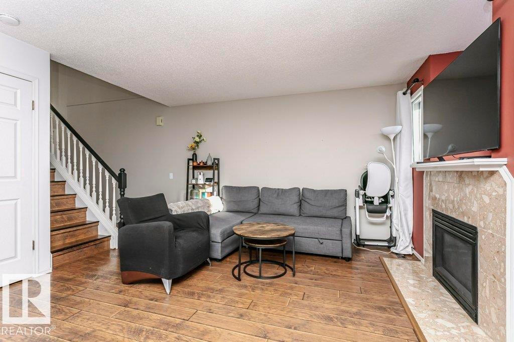 3 20 Deerbourne Drive, St. Albert, AB - Indoor Photo Showing Living Room With Fireplace