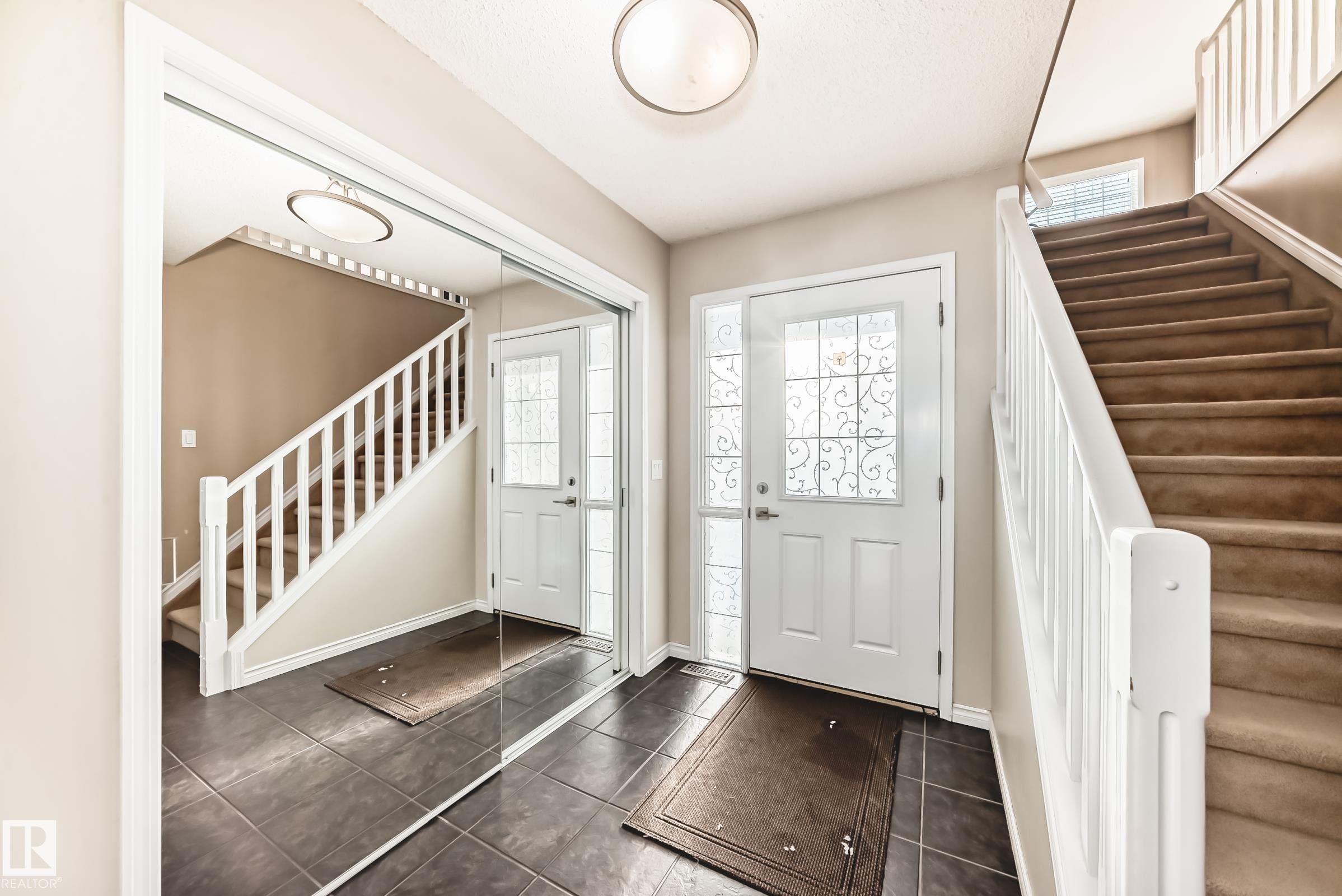 Entryway featuring stairway and dark tile patterned flooring - 5814 165 Avenue, Edmonton, AB - Indoor Photo Showing Other Room