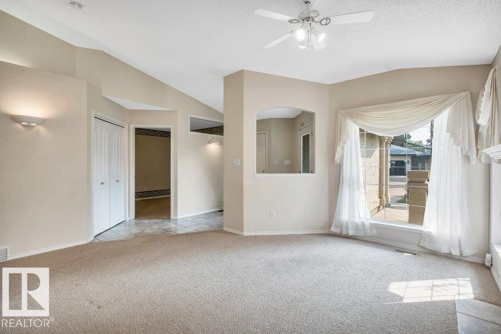 Unfurnished room featuring lofted ceiling, light carpet, and a ceiling fan - 112 Haddow Close, Edmonton, AB - Indoor Photo Showing Other Room