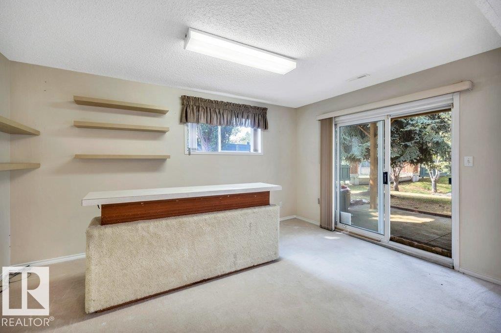 Bar area featuring light colored carpet, a textured ceiling, and light countertops - 112 Haddow Close, Edmonton, AB - Indoor Photo Showing Other Room
