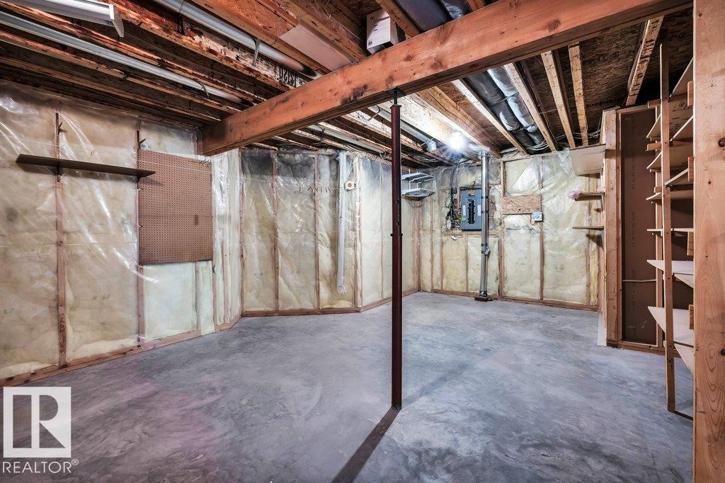Unfinished below grade area with electric panel - 112 Haddow Close, Edmonton, AB - Indoor Photo Showing Basement