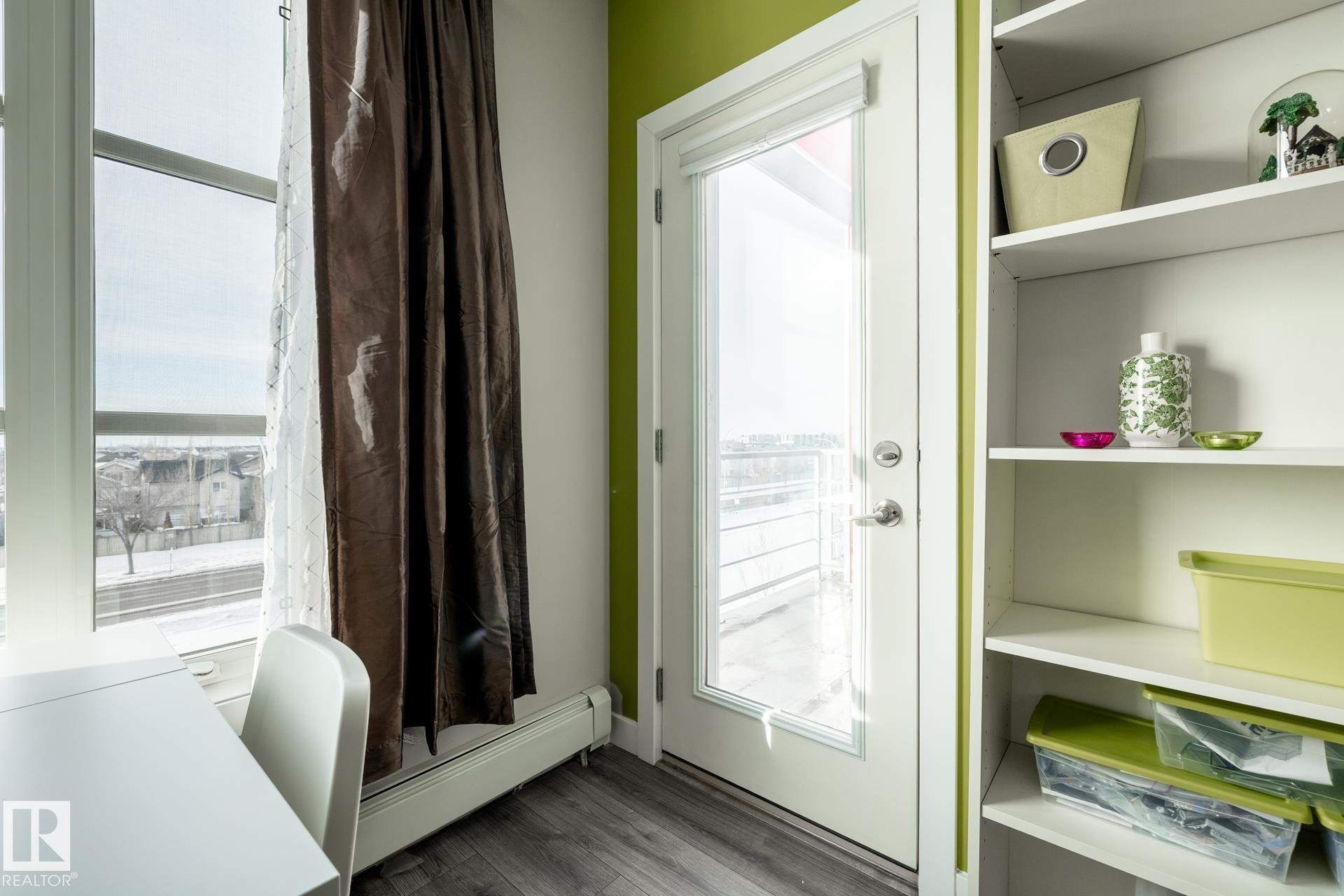 Entryway featuring a baseboard heating unit and wood finished floors - 407 2590 Anderson Way, Edmonton, AB - Indoor Photo Showing Other Room