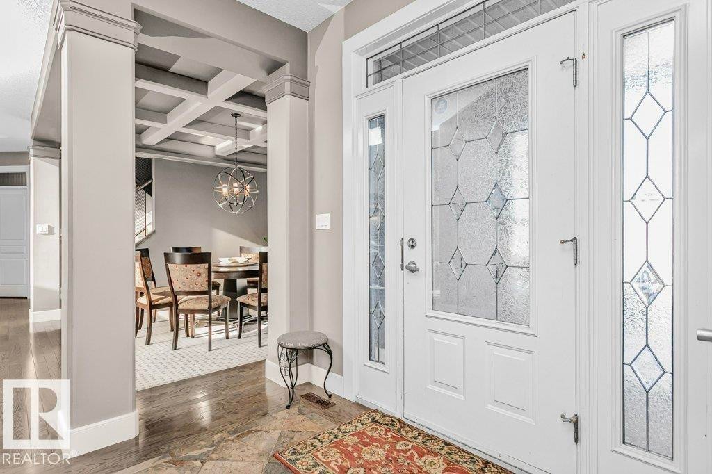 Foyer with coffered ceiling, dark wood-style floors, and a chandelier - 1579 Hector Road, Edmonton, AB - Indoor Photo Showing Other Room