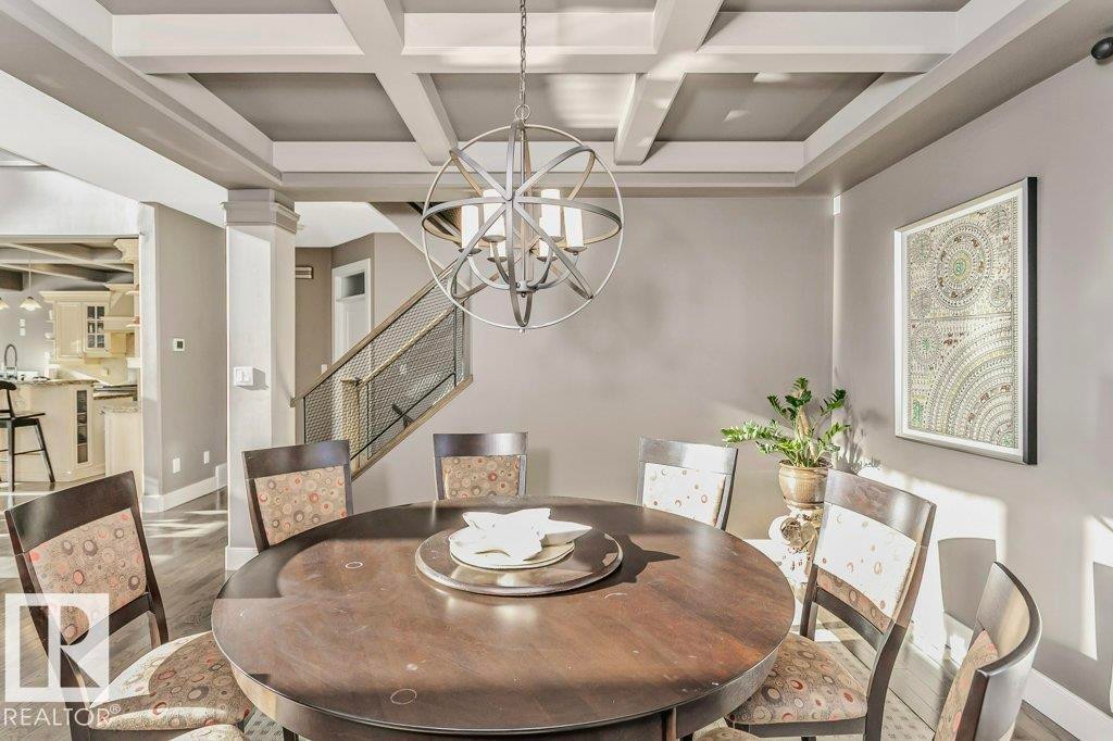 Dining area featuring coffered ceiling, wood finished floors, suspended lighting, and ornate columns - 1579 Hector Road, Edmonton, AB - Indoor Photo Showing Dining Room