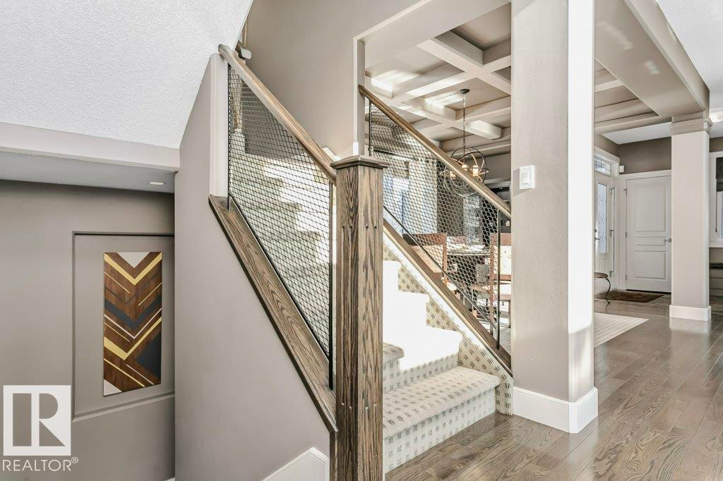 Staircase with wood finished floors and baseboards - 1579 Hector Road, Edmonton, AB - Indoor Photo Showing Other Room