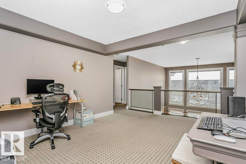 Office area with a chandelier, a textured ceiling, and light carpet - 1579 Hector Road, Edmonton, AB - Indoor Photo Showing Other Room