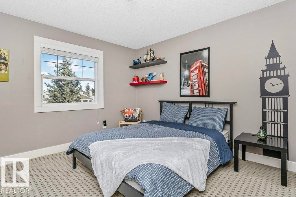 Bedroom featuring a textured ceiling and light colored carpet - 1579 Hector Road, Edmonton, AB - Indoor Photo Showing Bedroom