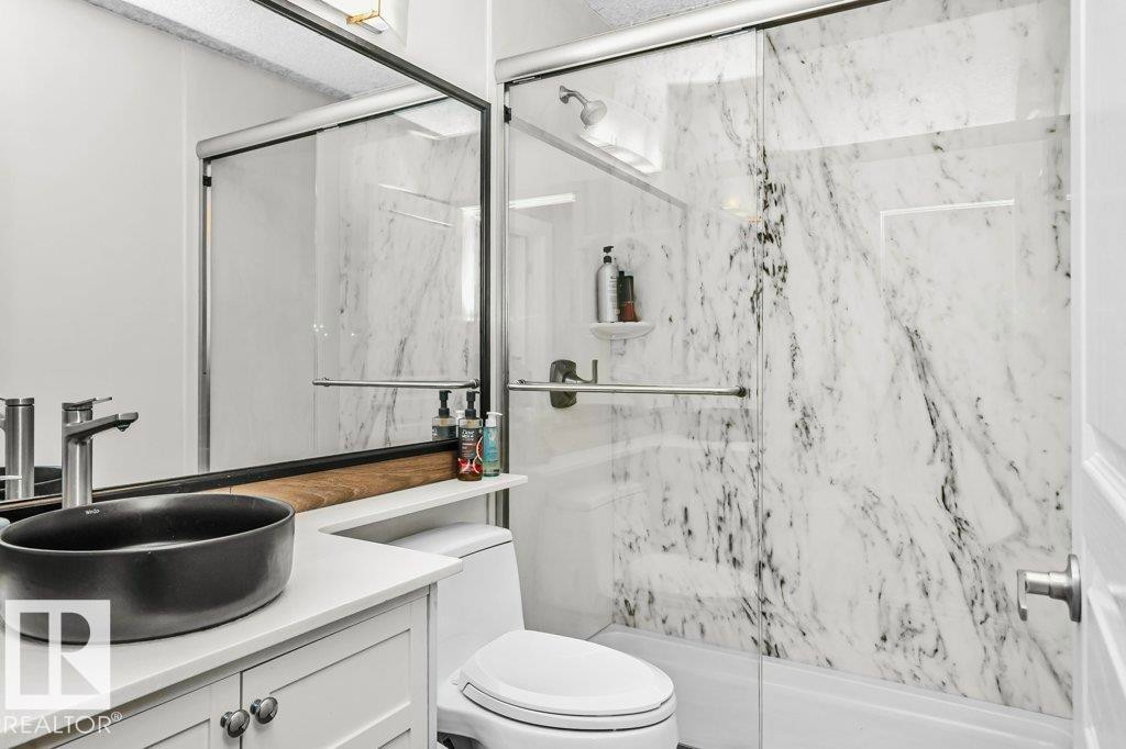 Bathroom with vanity and a marble finish shower - 1579 Hector Road, Edmonton, AB - Indoor Photo Showing Bathroom
