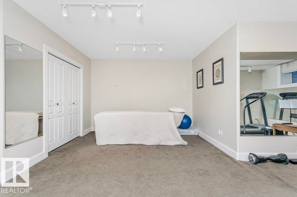 Bedroom with carpet flooring and a closet - 1579 Hector Road, Edmonton, AB - Indoor