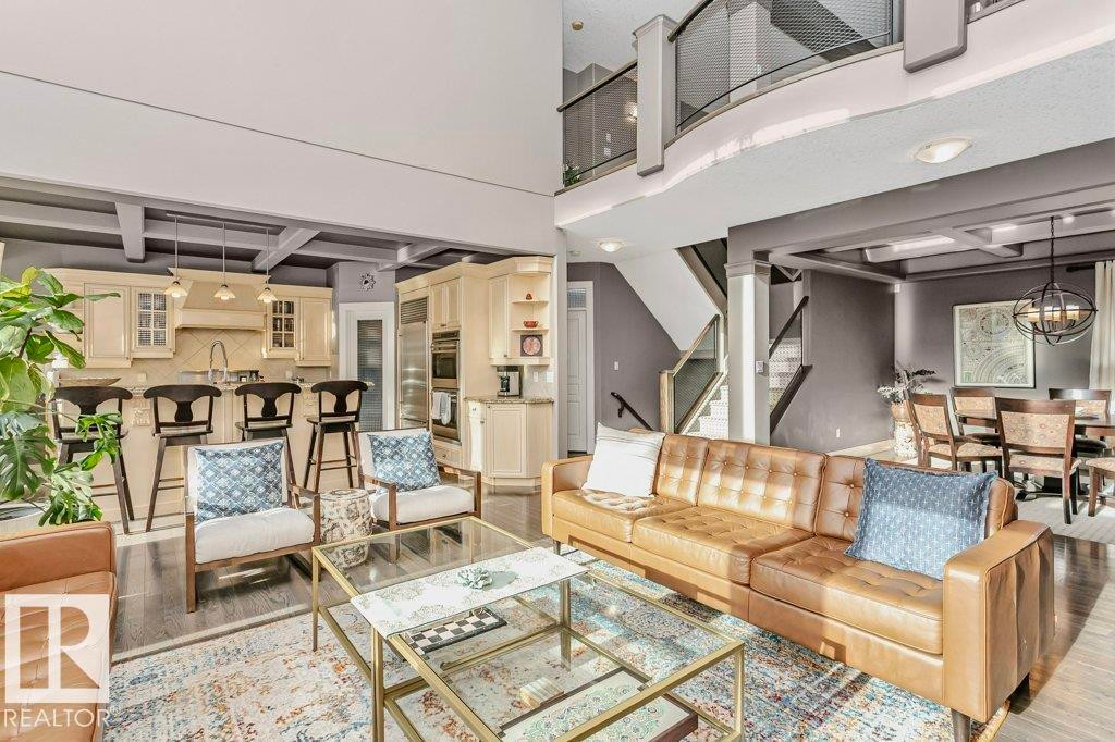 Living area with light wood finished floors, coffered ceiling, and suspended lighting - 1579 Hector Road, Edmonton, AB - Indoor Photo Showing Living Room