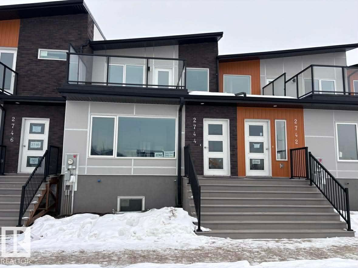 Snow covered property with brick siding and a balcony - 2750 Blatchford Road Nw, Edmonton, AB - Outdoor With Balcony