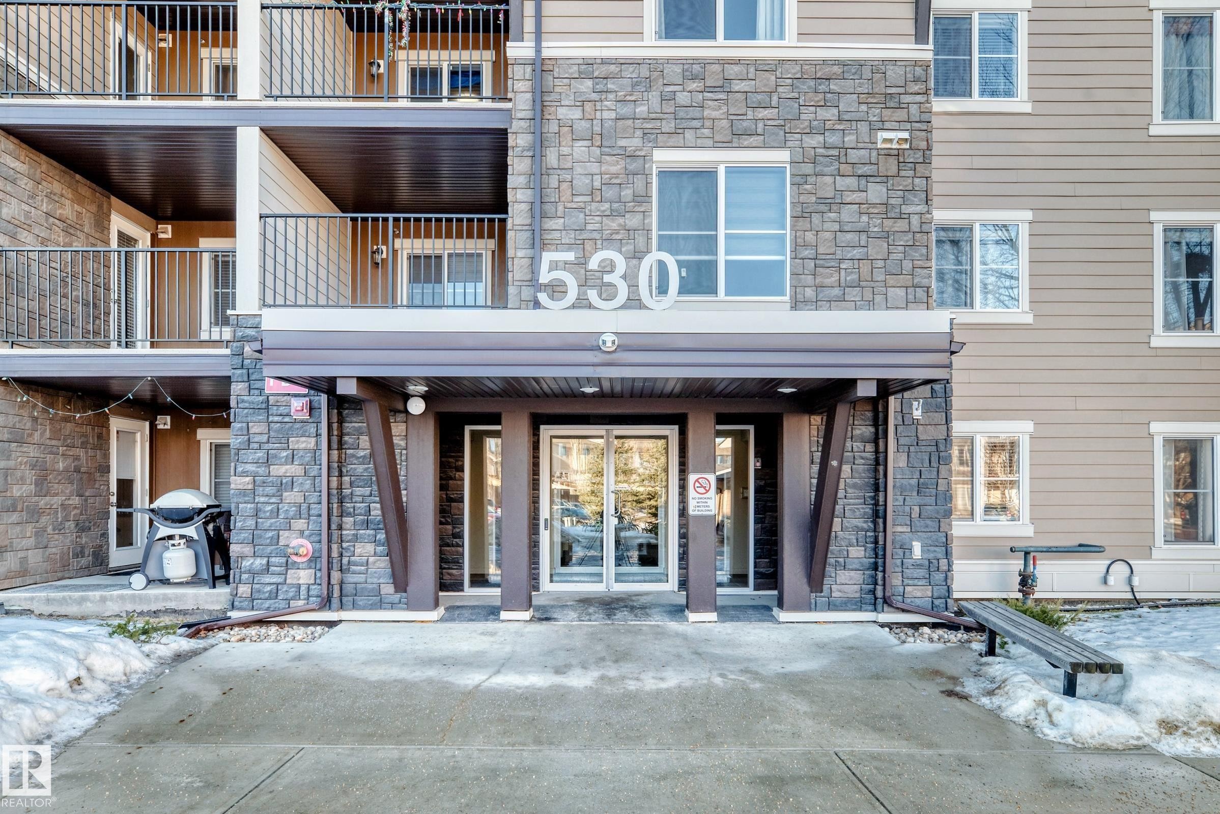 Entrance to property featuring stone siding - 302 530 Watt Boulevard Sw, Edmonton, AB - Outdoor With Balcony With Facade