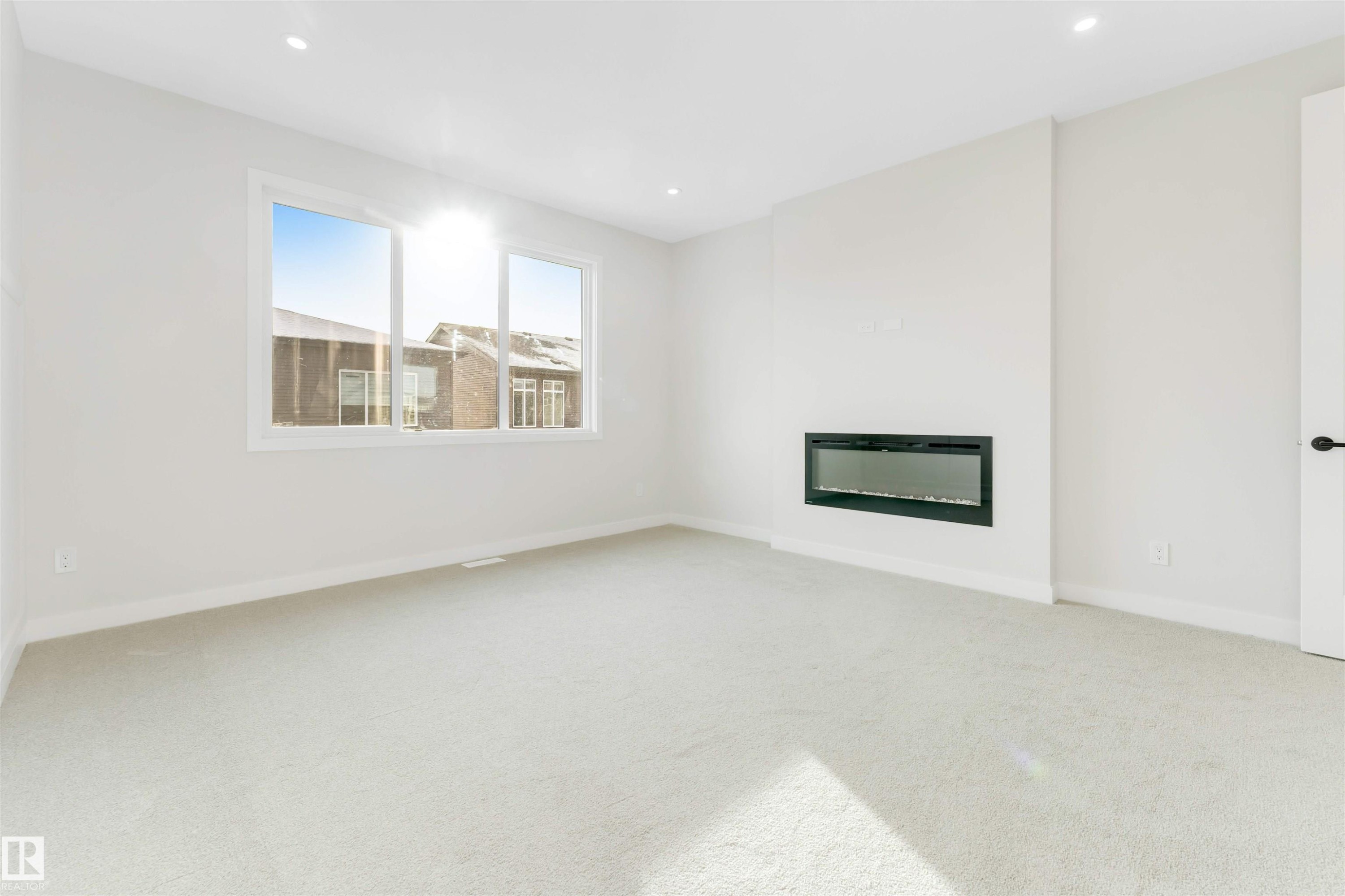 5807 Kootook Link Link, Edmonton, AB - Indoor Photo Showing Other Room With Fireplace