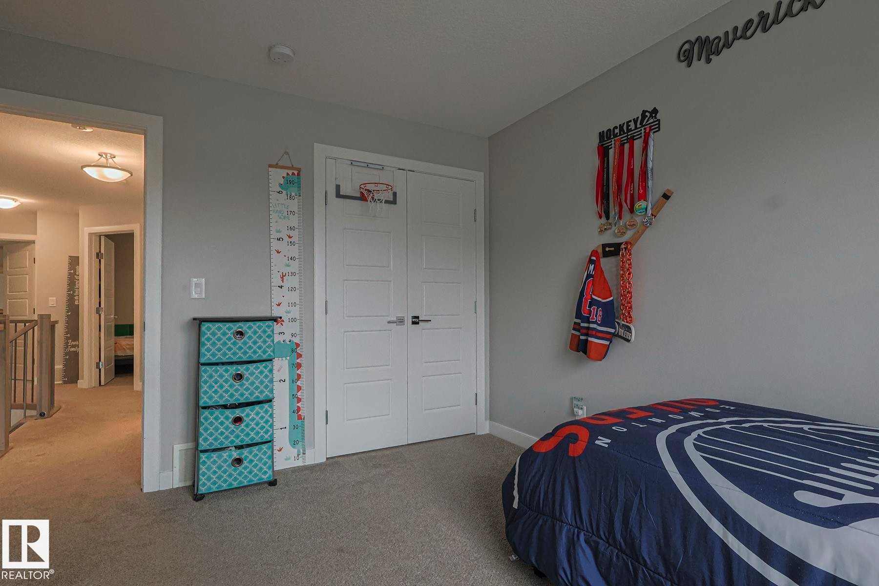Bedroom with carpet flooring and a closet - 2011 201 Street, Edmonton, AB - Indoor Photo Showing Bedroom