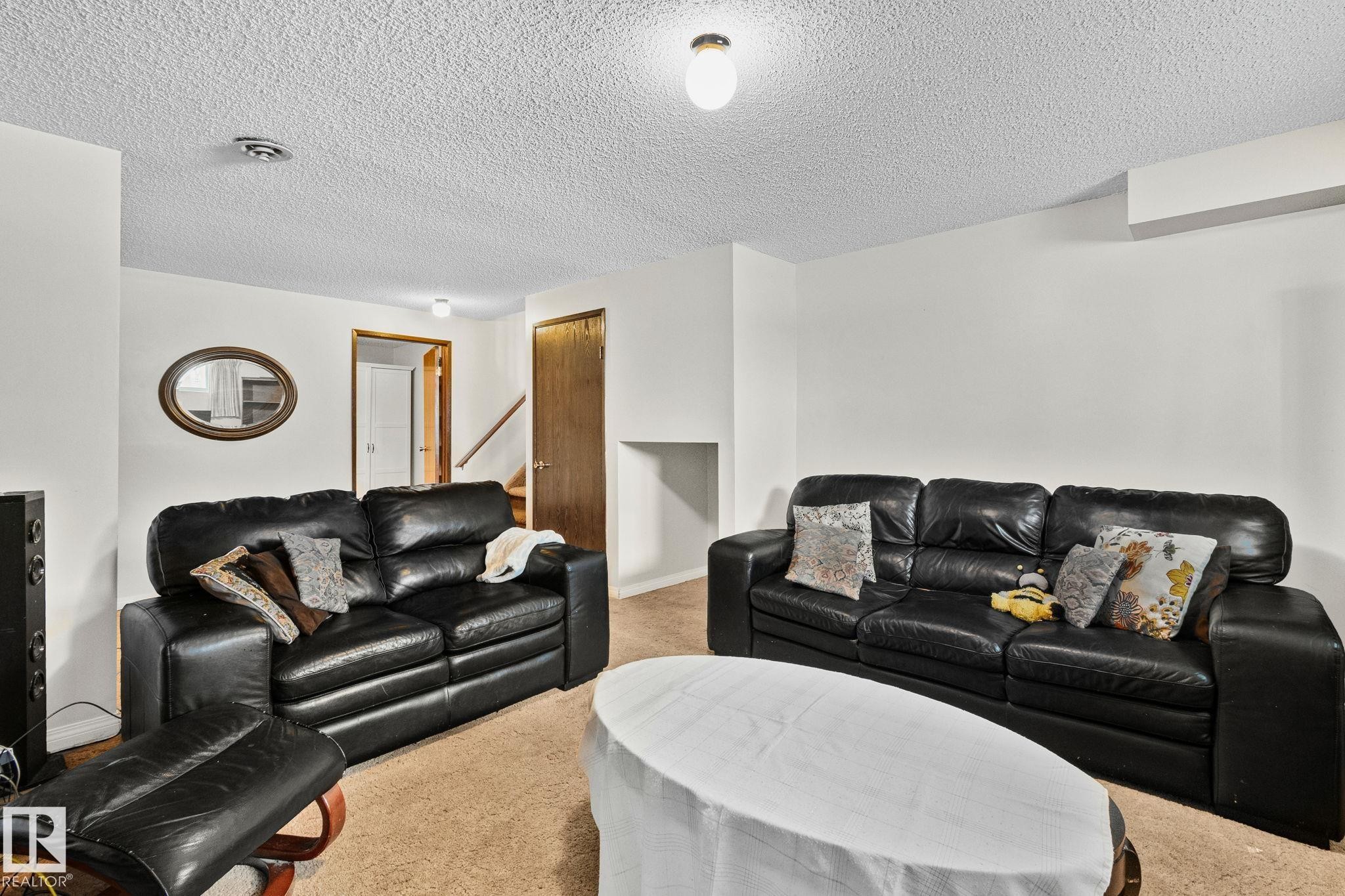 Carpeted living room featuring a textured ceiling - 17523 95 Street, Edmonton, AB - Indoor Photo Showing Living Room
