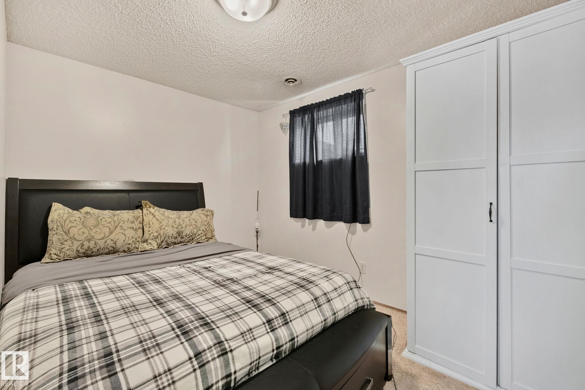 Bedroom with a textured ceiling and light colored carpet - 17523 95 Street, Edmonton, AB - Indoor Photo Showing Bedroom
