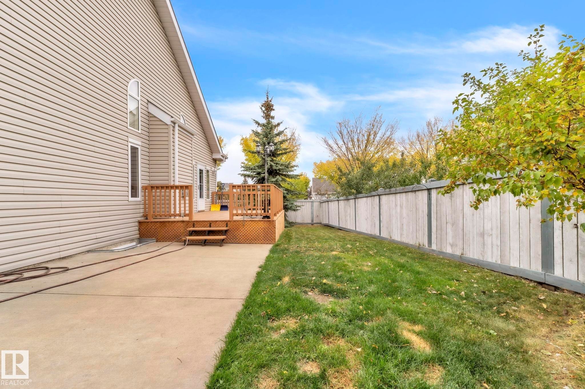 Fenced backyard featuring a wooden deck - 1217 Summerside Drive, Edmonton, AB - Outdoor With Deck Patio Veranda