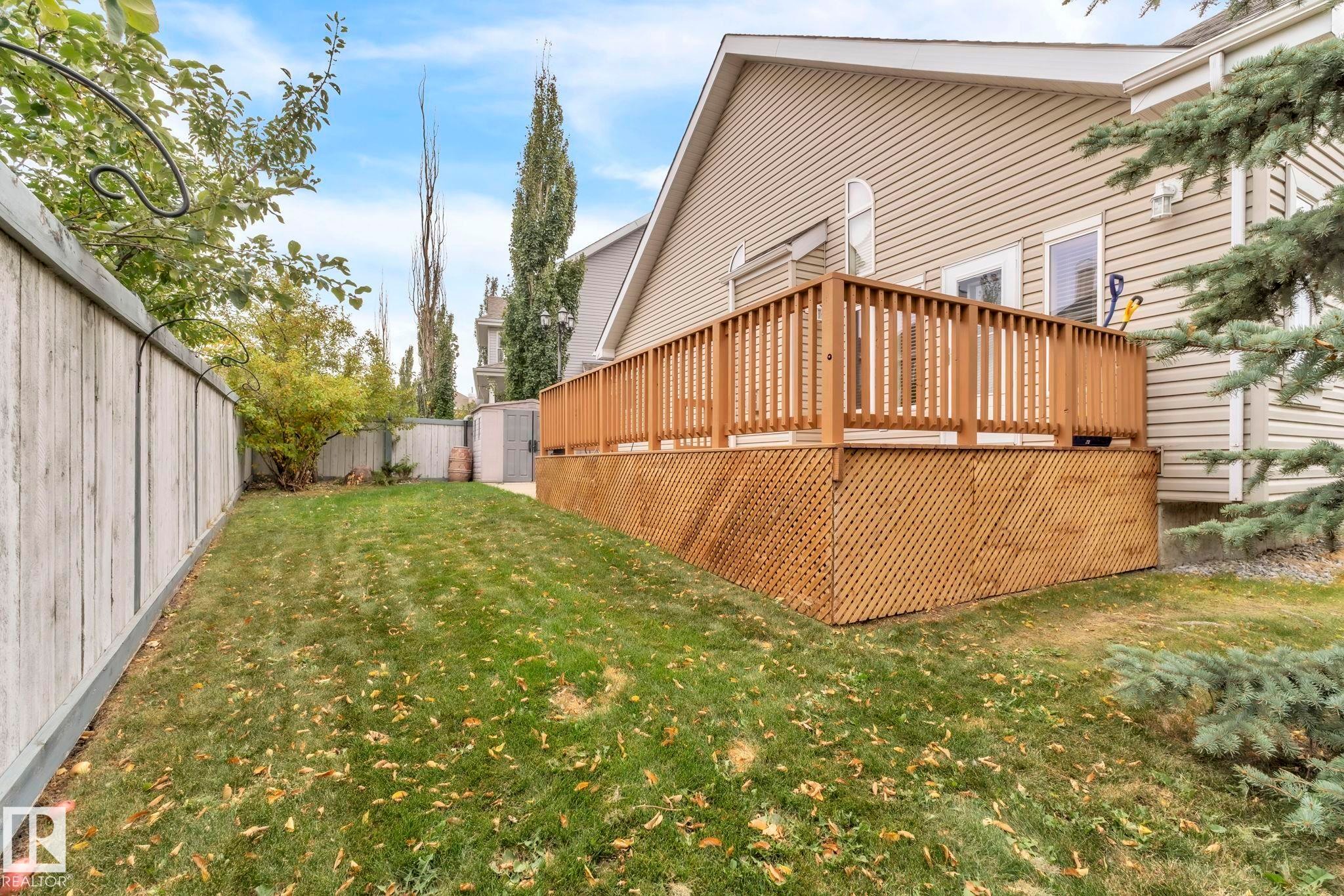 Fenced backyard with a shed and a wooden deck - loads of privacy on a corner lot! - 1217 Summerside Drive, Edmonton, AB - Outdoor