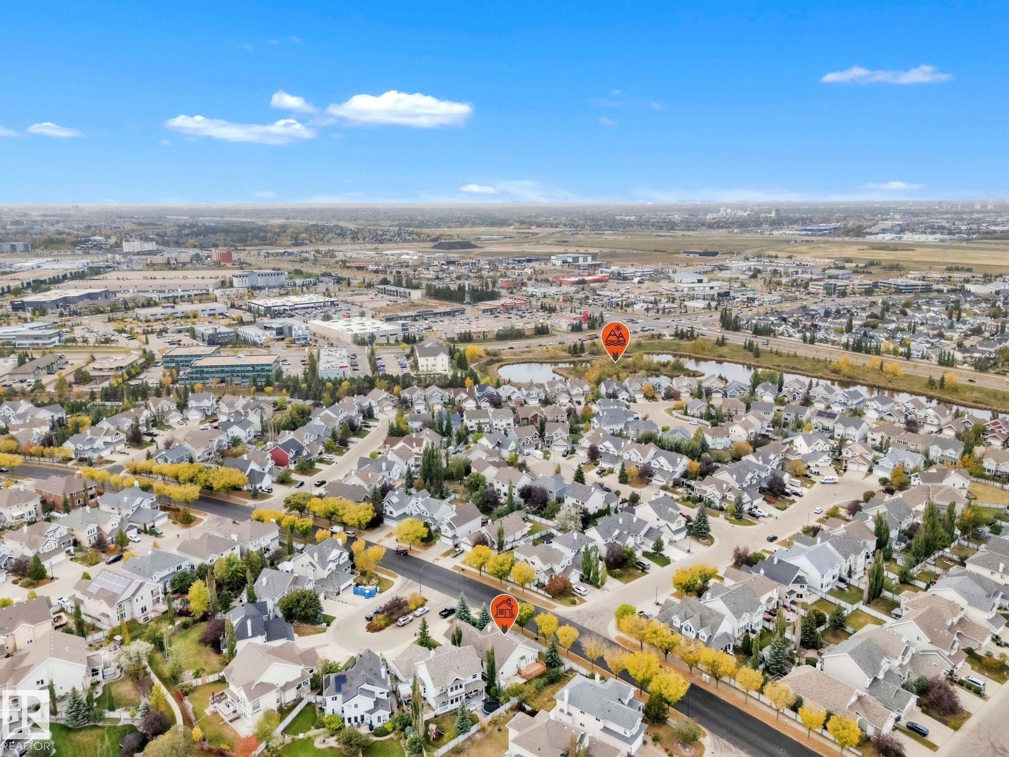 Aerial view of property's location with a large body of water and nearby suburban area - 1217 Summerside Drive, Edmonton, AB - Outdoor With View