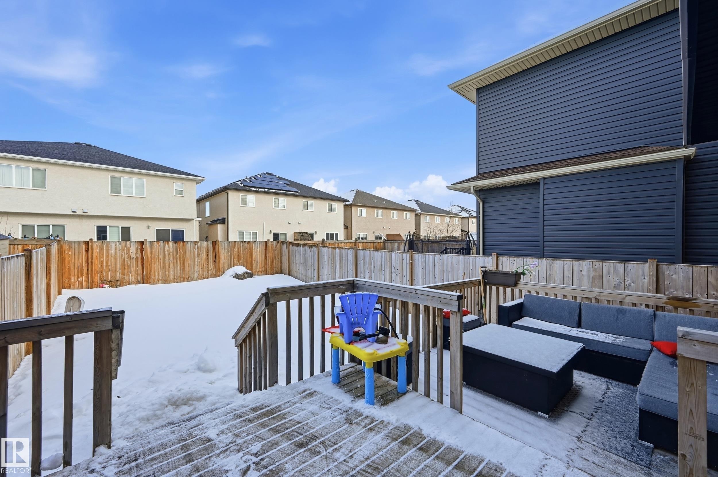 Wooden terrace with a residential view, a fenced backyard, and an outdoor hangout area - 5978 167C Avenue, Edmonton, AB - Outdoor With Deck Patio Veranda With Exterior