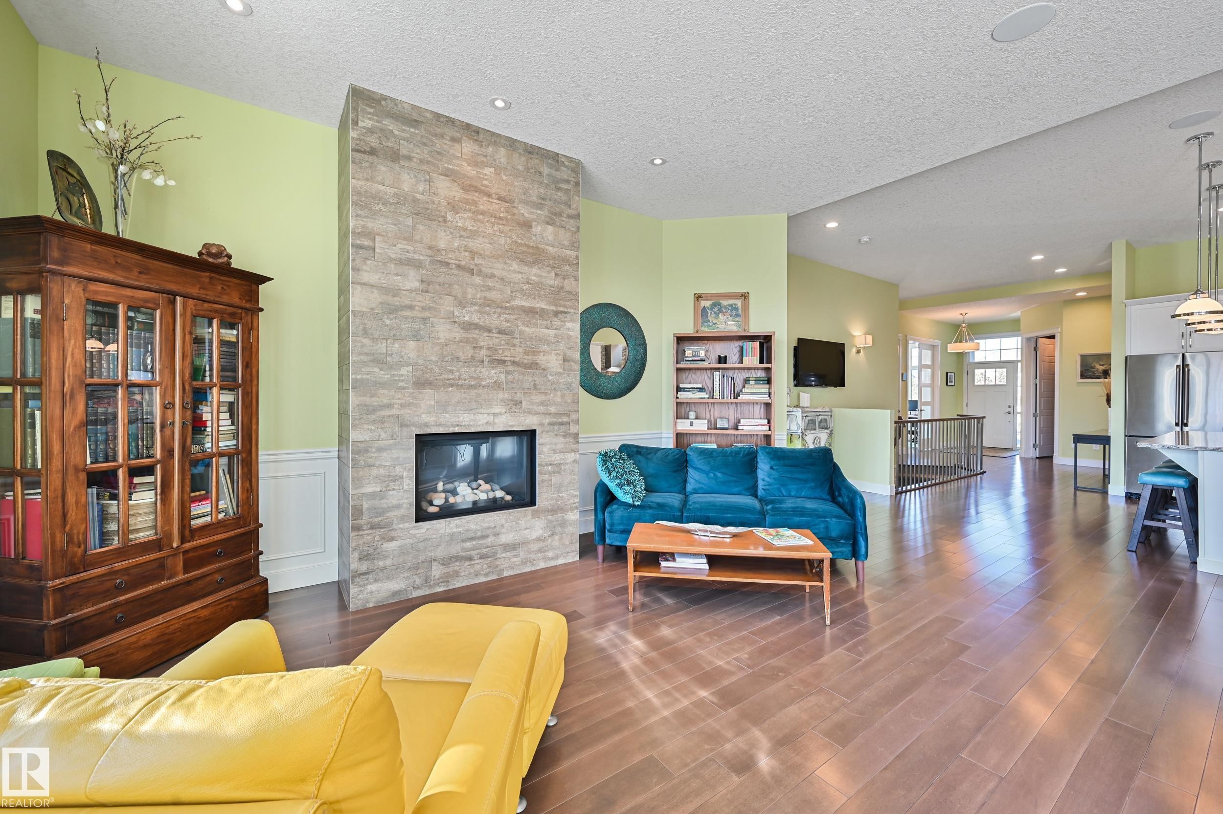 1 7570 May Common, Edmonton, AB - Indoor Photo Showing Living Room With Fireplace