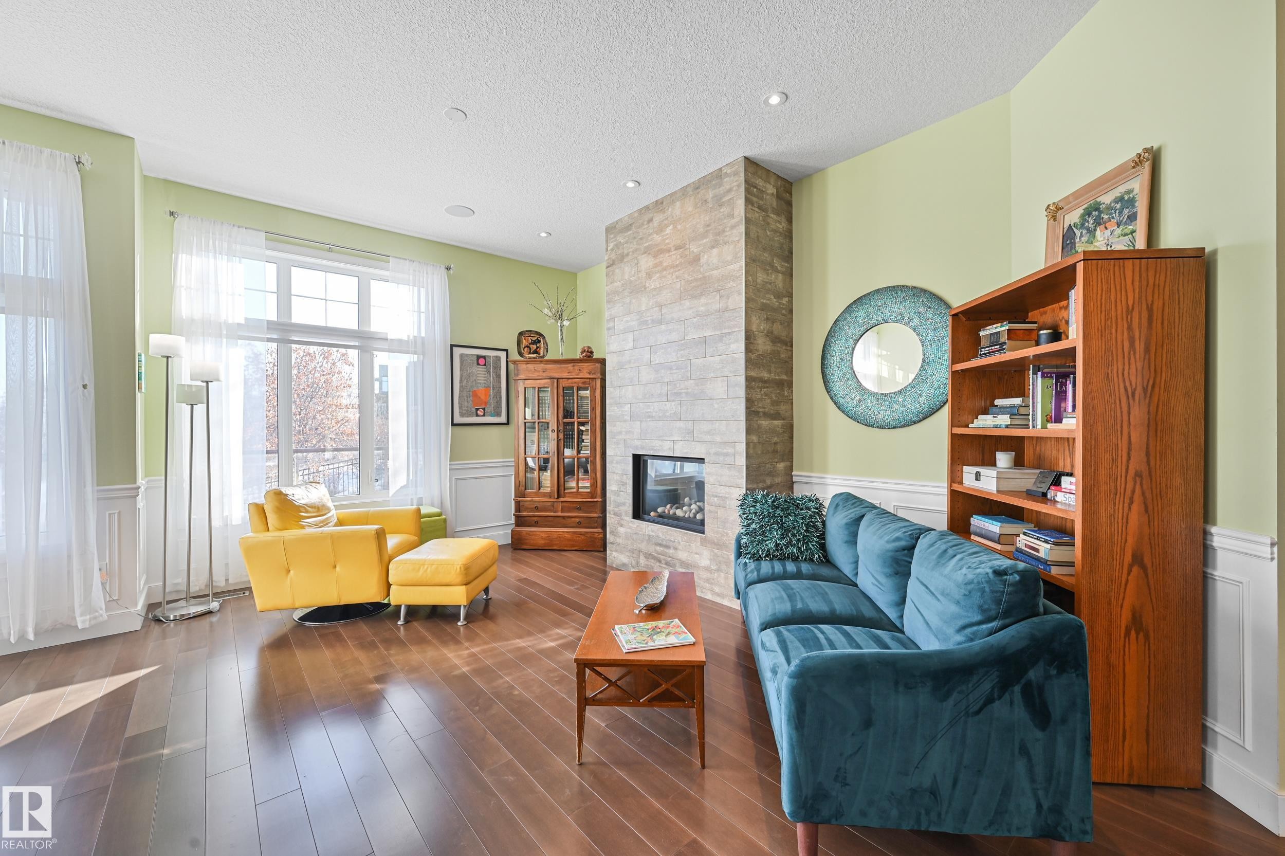 1 7570 May Common, Edmonton, AB - Indoor Photo Showing Living Room With Fireplace