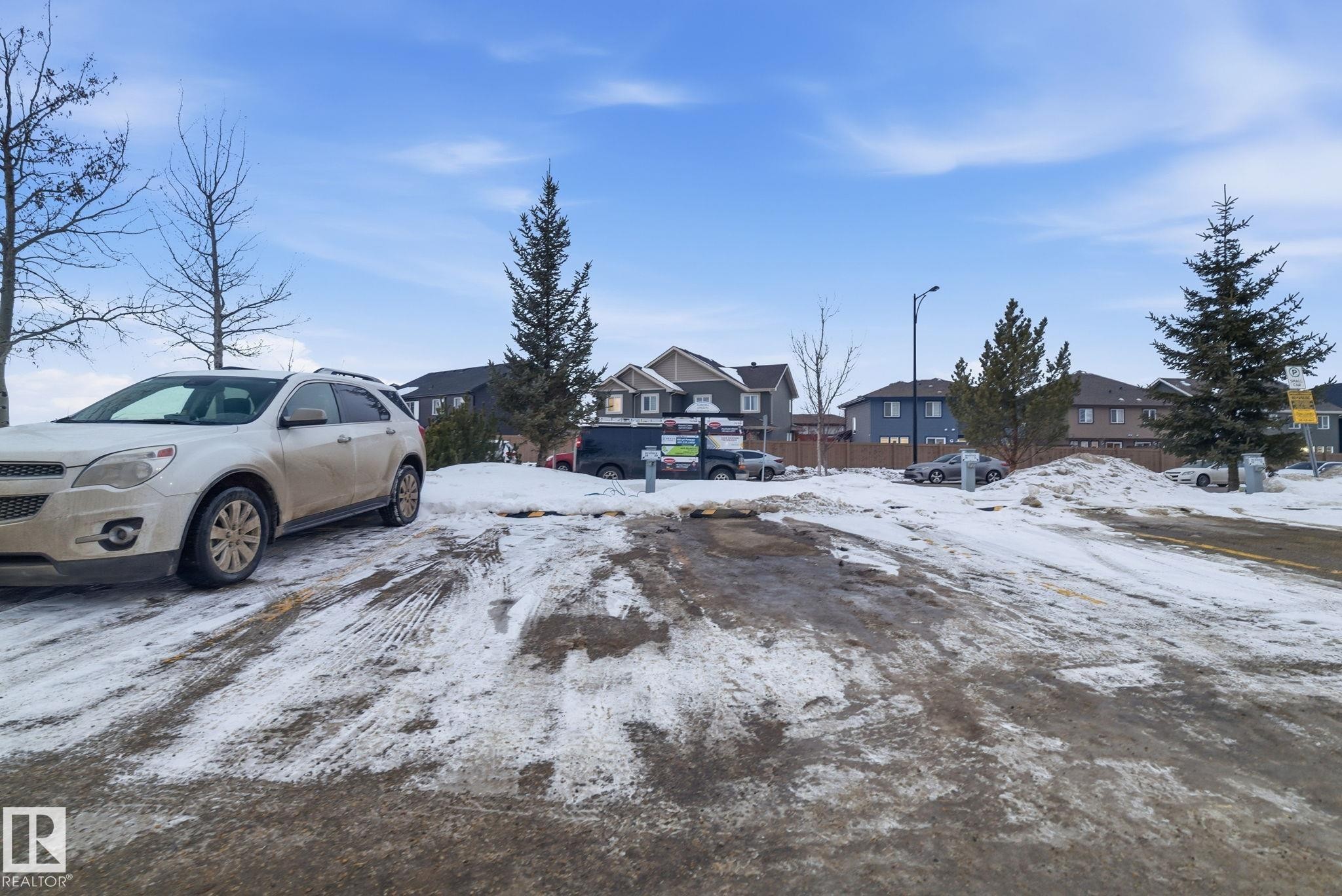 Yard layered in snow featuring a residential view - 424 1510 Watt Drive, Edmonton, AB - Outdoor