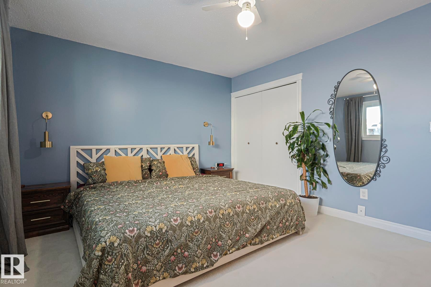 Bedroom featuring a closet, light carpet, and a ceiling fan - 192 Dunluce Road, Edmonton, AB - Indoor Photo Showing Bedroom