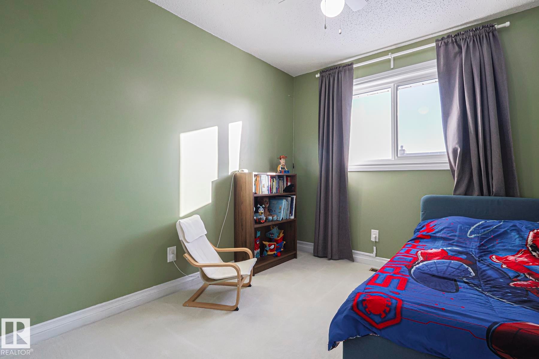 Carpeted bedroom with ceiling fan and a textured ceiling - 192 Dunluce Road, Edmonton, AB - Indoor Photo Showing Bedroom