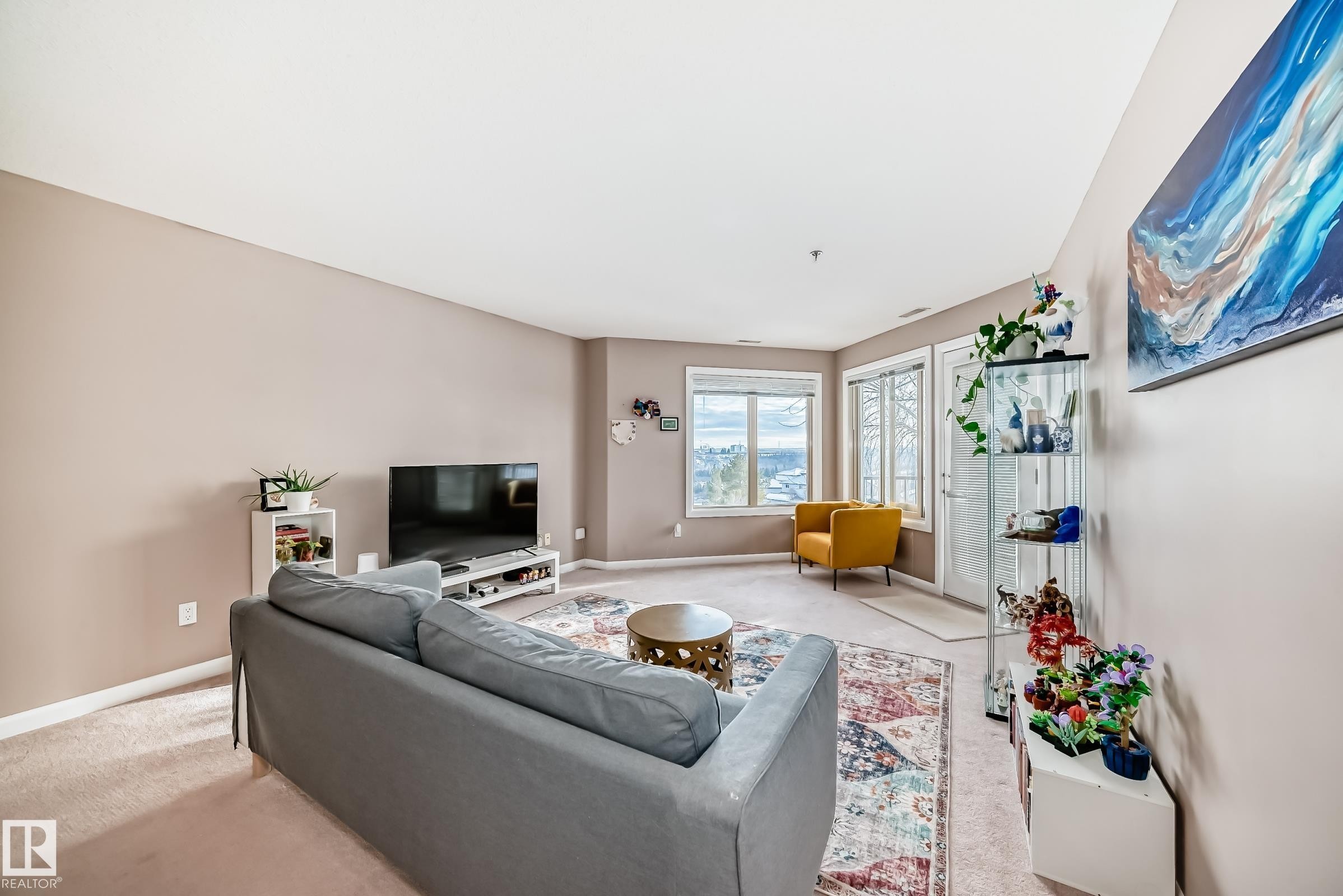 Living room with baseboards and carpet - 232 530 Hooke Road, Edmonton, AB - Indoor Photo Showing Other Room
