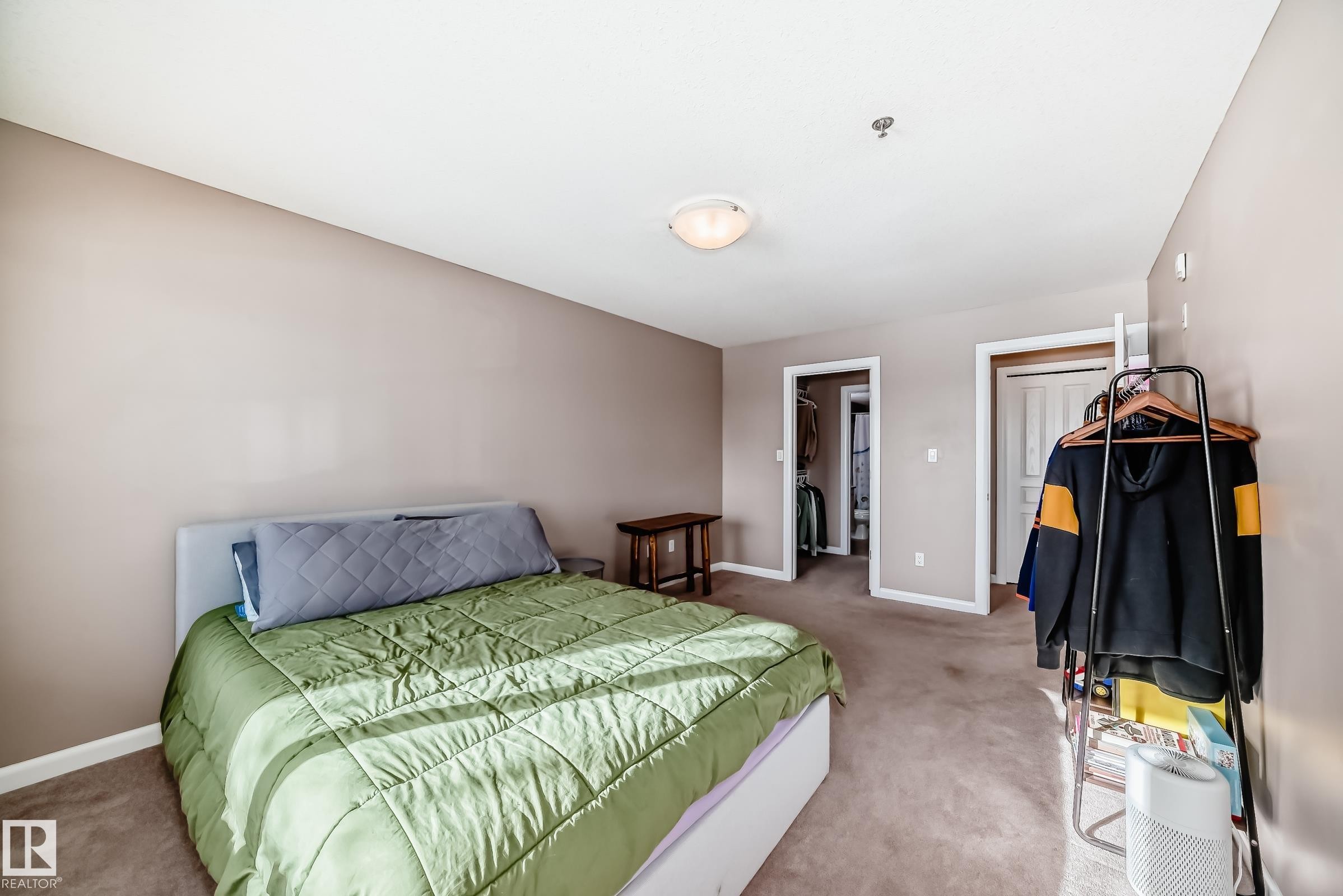 Carpeted bedroom with baseboards and a spacious closet - 232 530 Hooke Road, Edmonton, AB - Indoor Photo Showing Bedroom