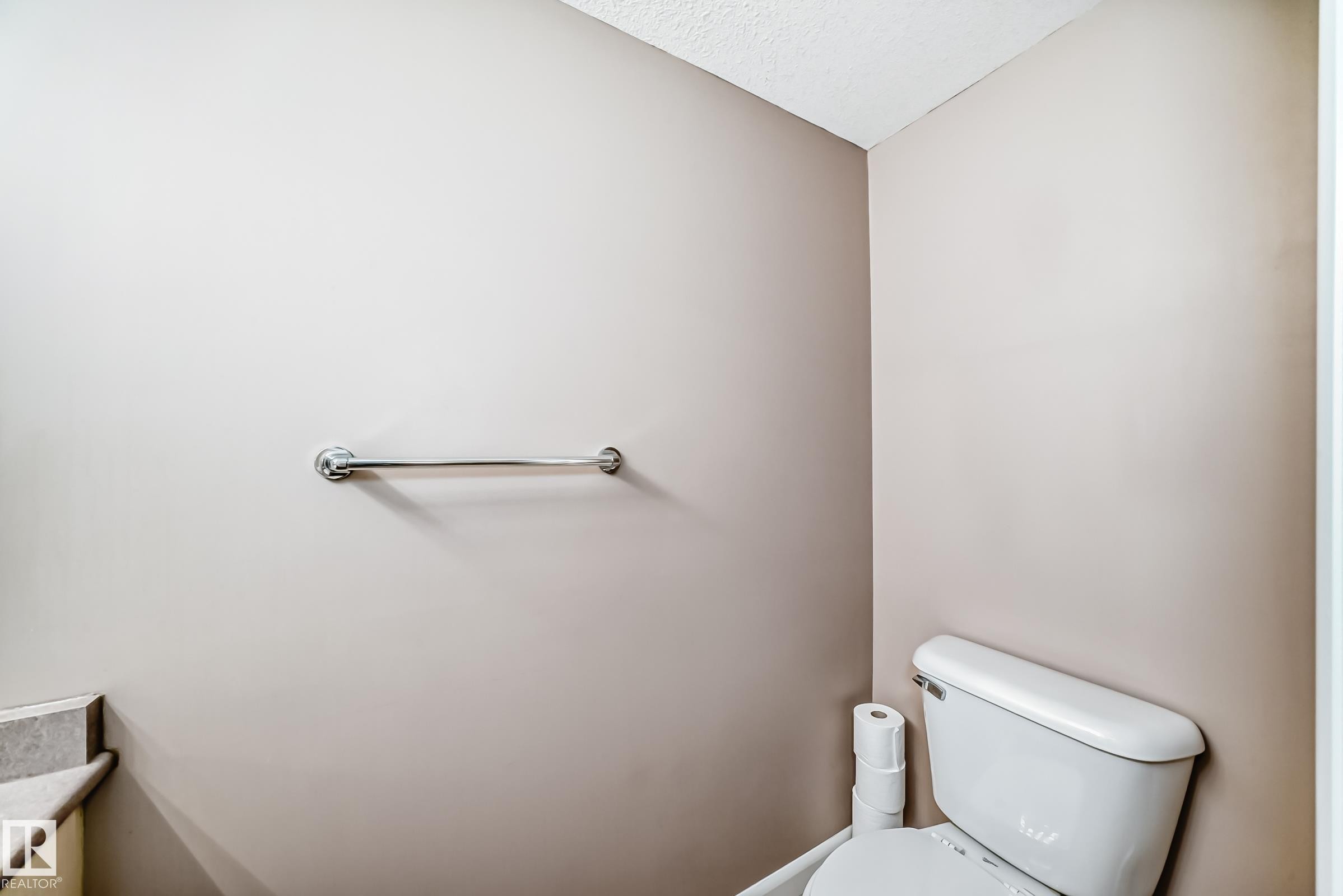 Half bath featuring toilet and a textured ceiling - 232 530 Hooke Road, Edmonton, AB - Indoor Photo Showing Bathroom
