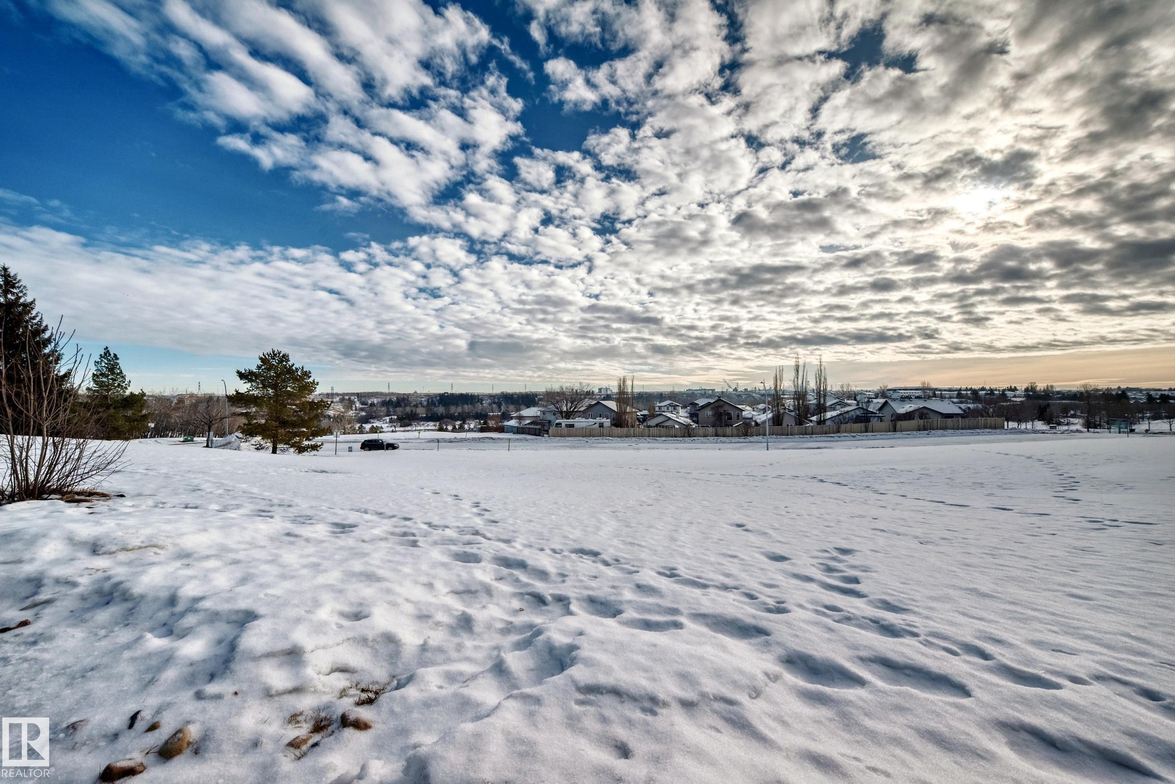 Yard layered in snow with a residential view - 232 530 Hooke Road, Edmonton, AB - Outdoor With View